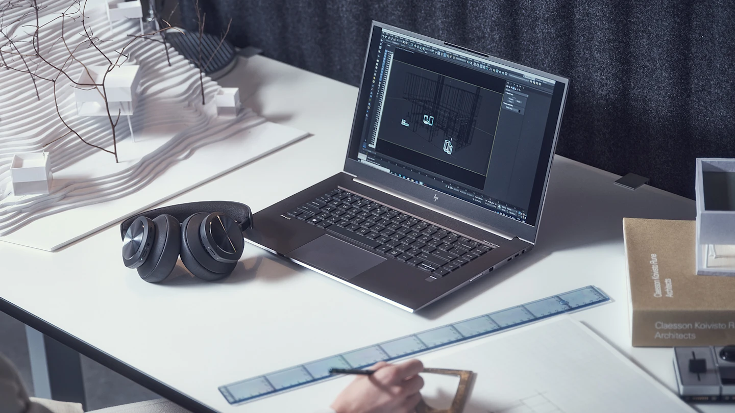 Bir çalışma masasında ve bir dizüstü bilgisayara bağlı Beoplay Portal