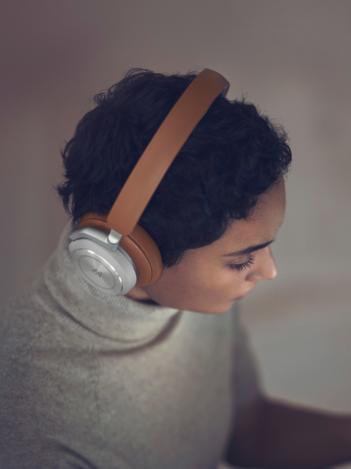 A woman wearing Beoplay HX Timber while working