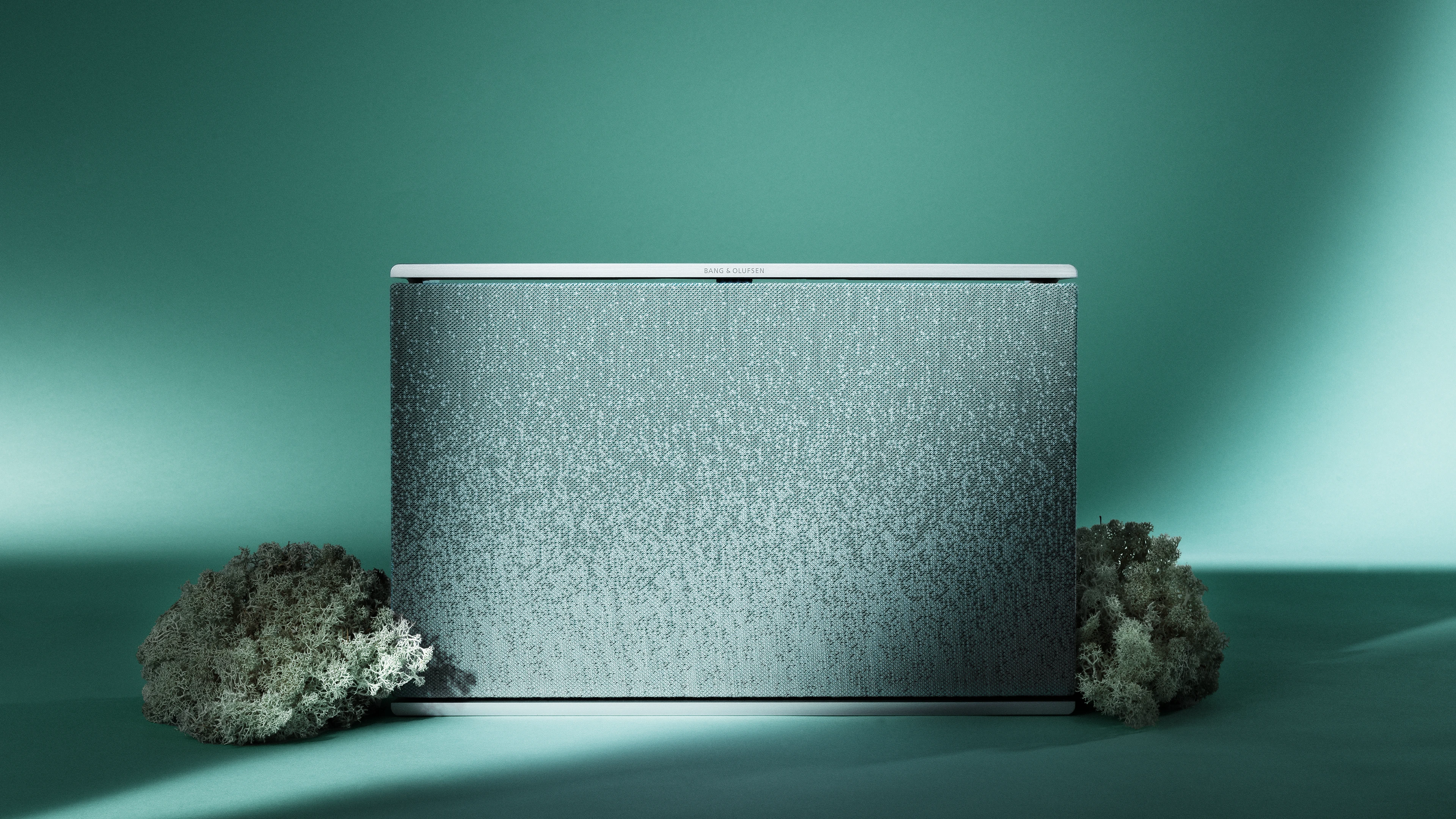 Beosound Level ATelier Frosted Green protrayed with a green background