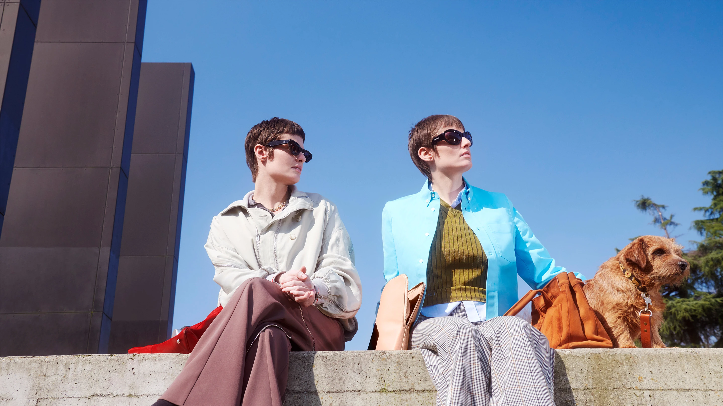 Medea sisters sitting in the park with their dog