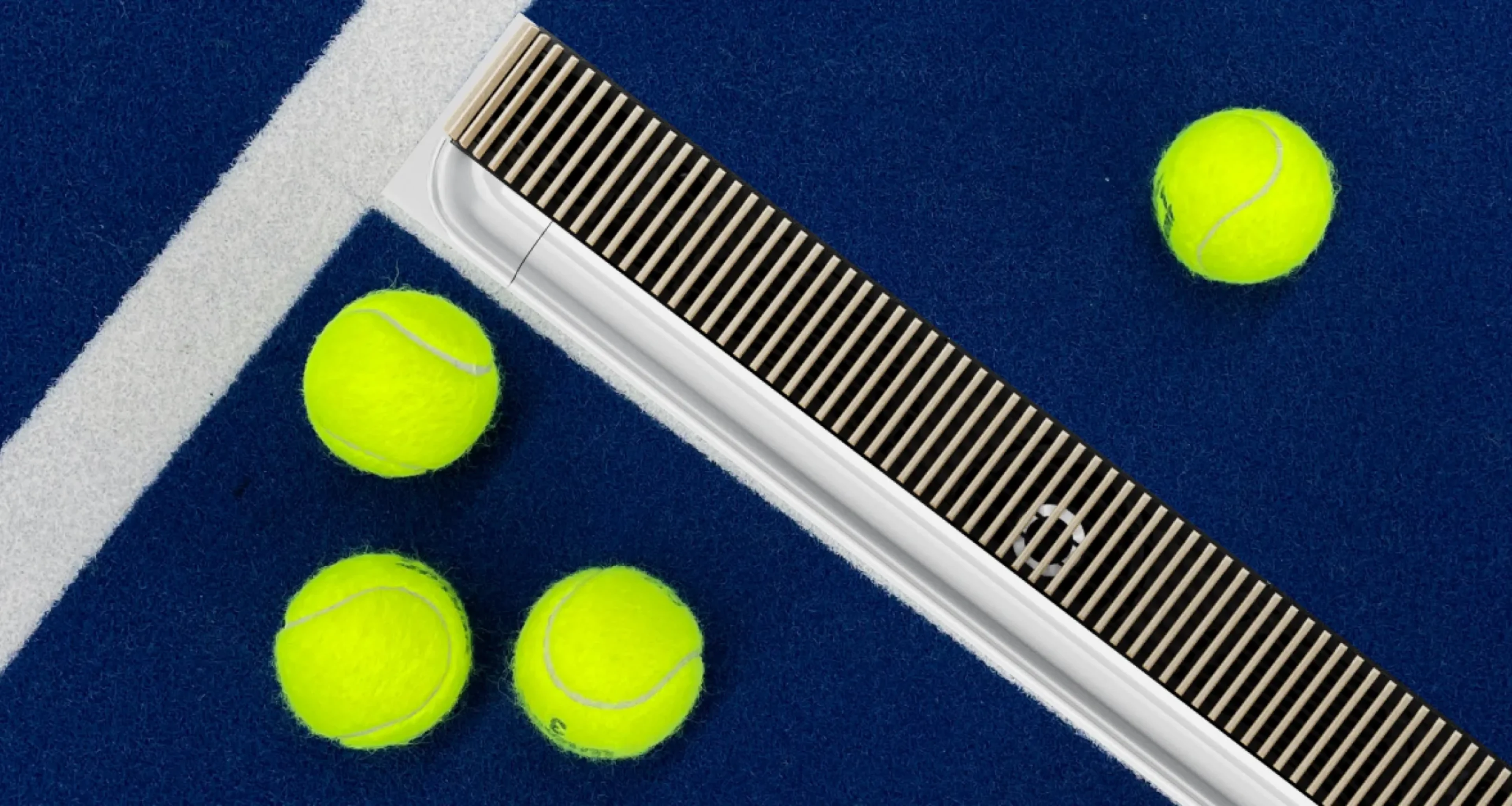 Beosound Premiere on a dark blue tennis field with yellow tennis balls