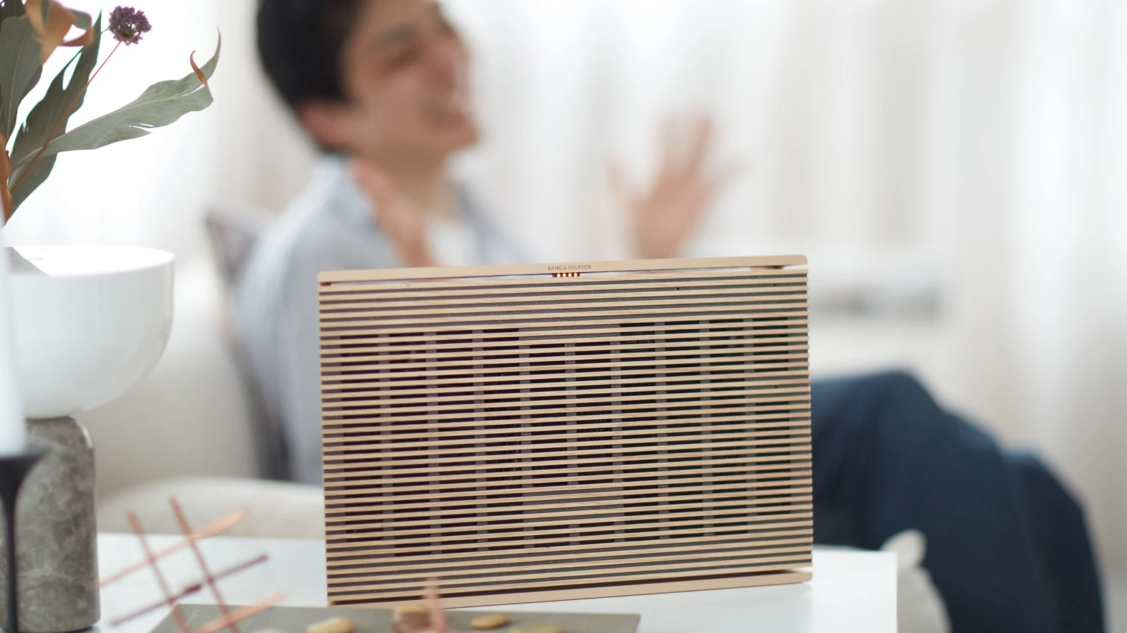 Image of Beosound Level in Gold Tone on a table