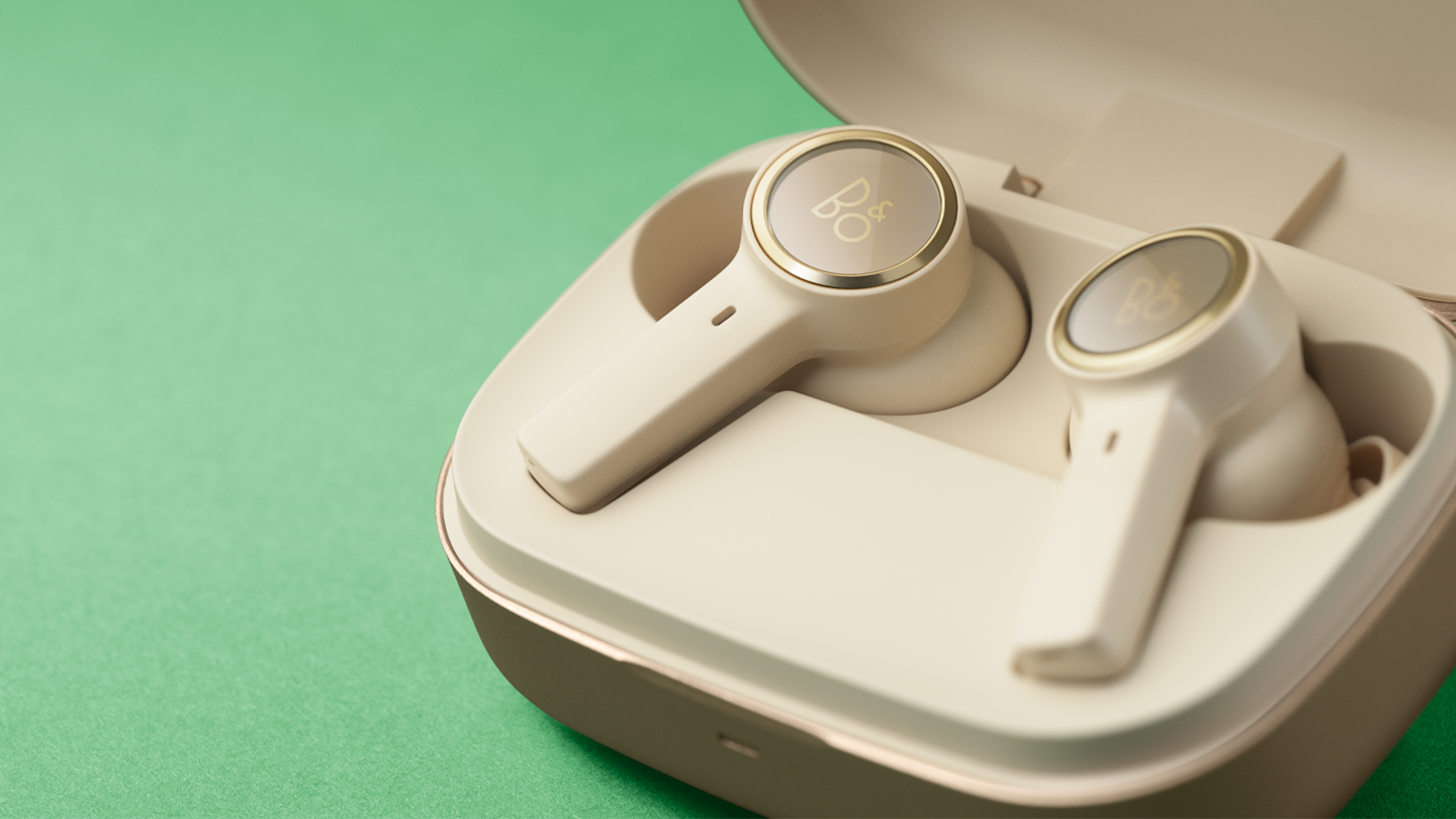 Beoplay EX in gold inside the charging case