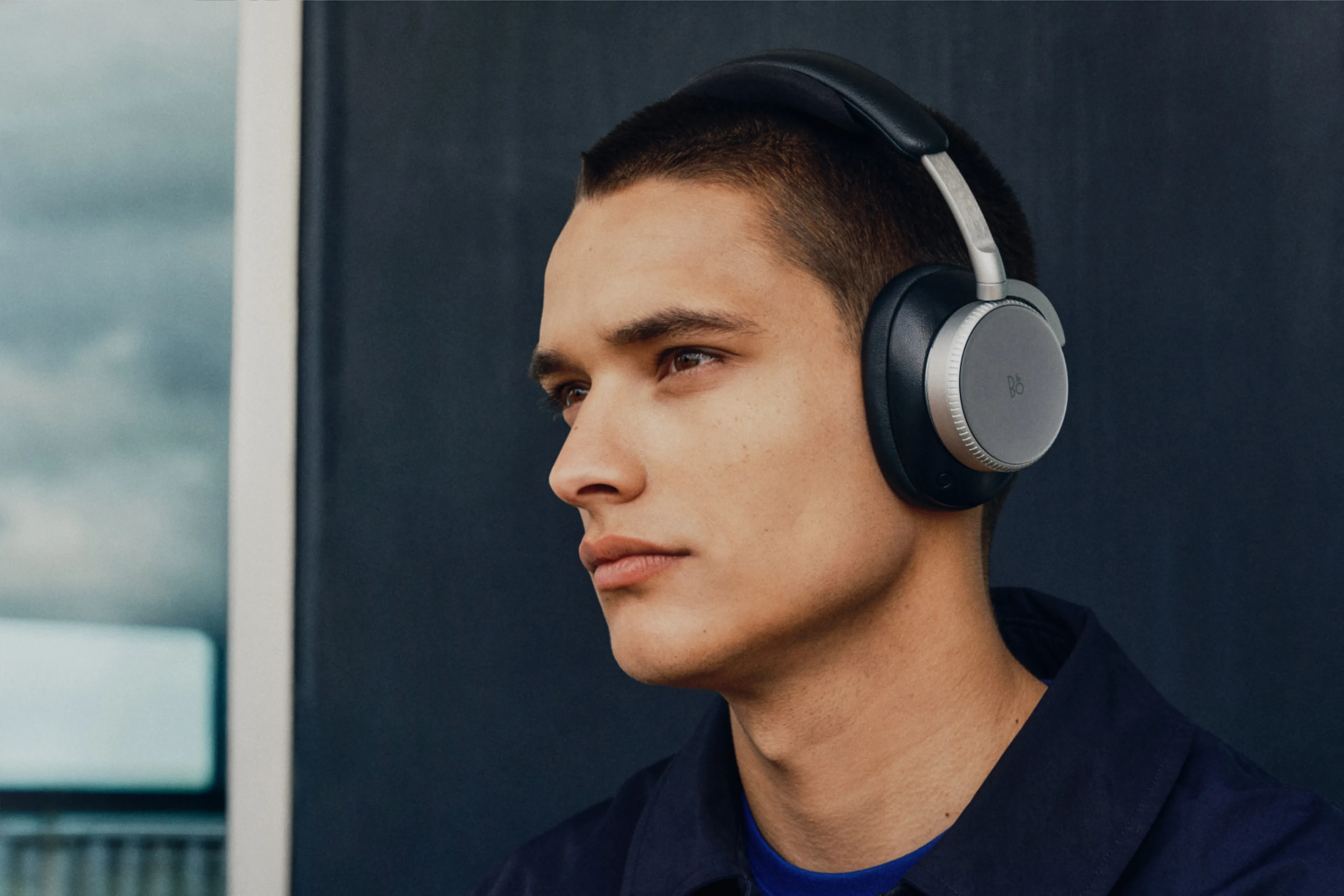 A man wearing H100 infinite black while looking to his side