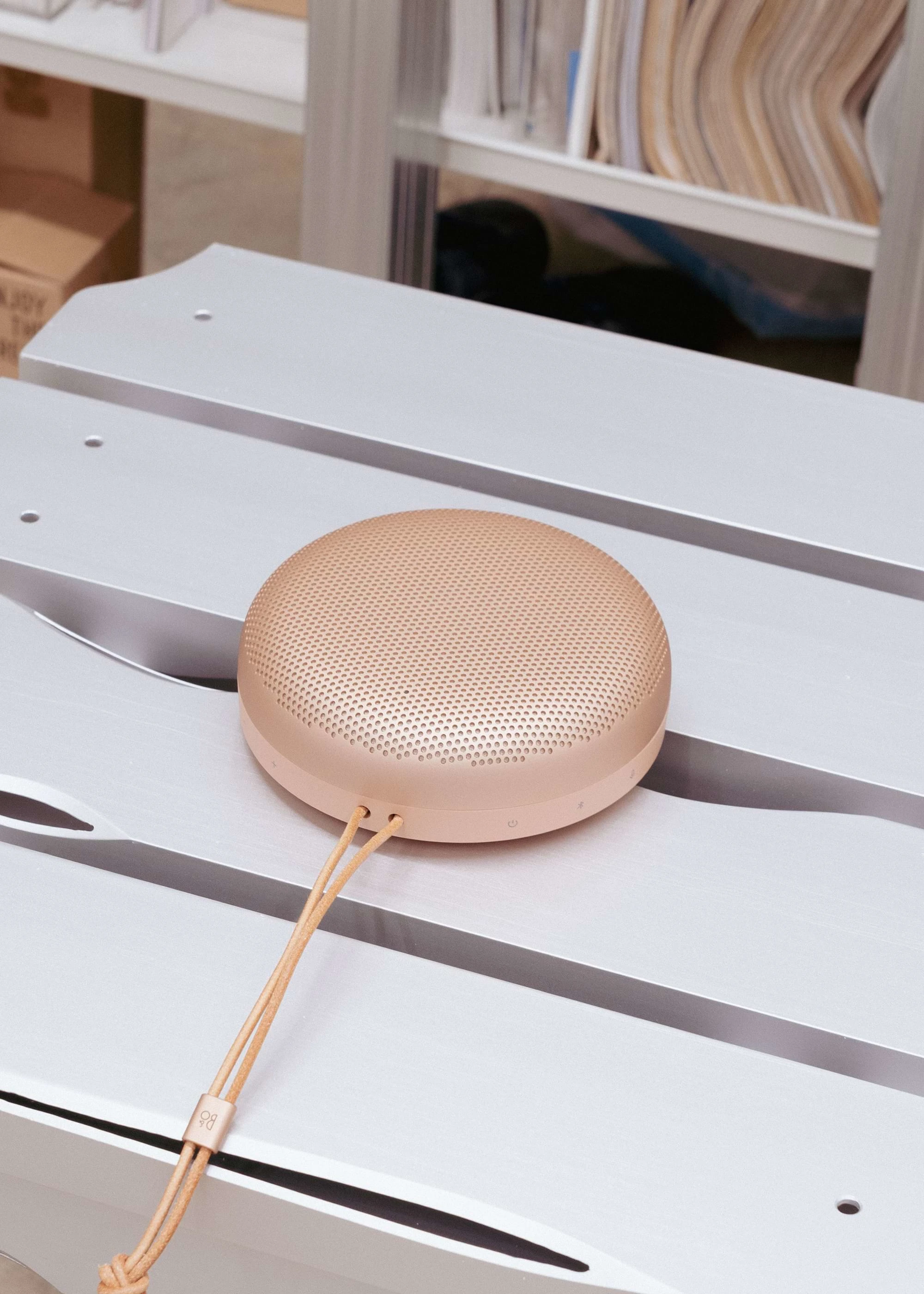 Beosound A1 laying on a surface in a warehouse