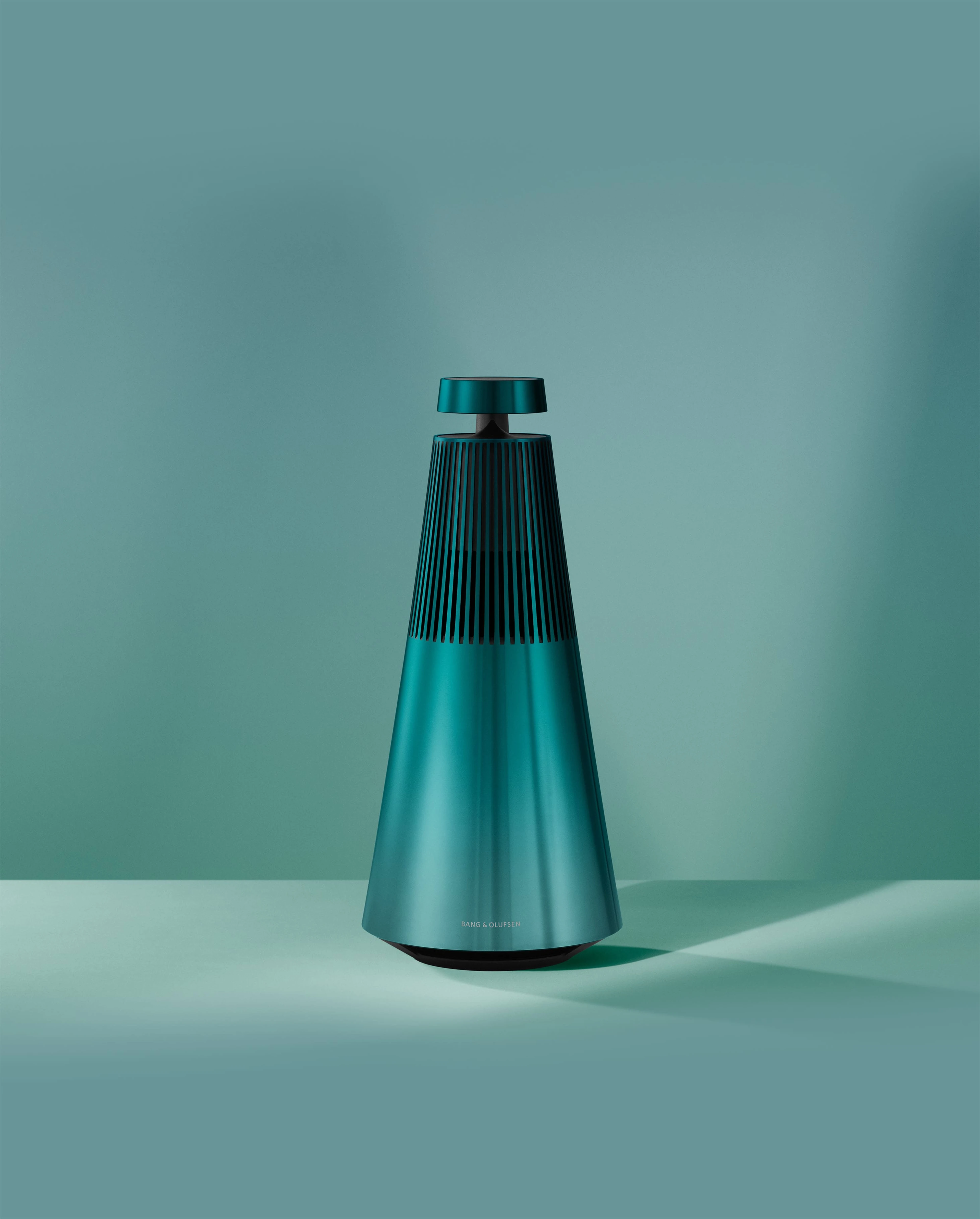 Image of Beosound 2 in Northern Sky Turquoise from the front with plain turquoise