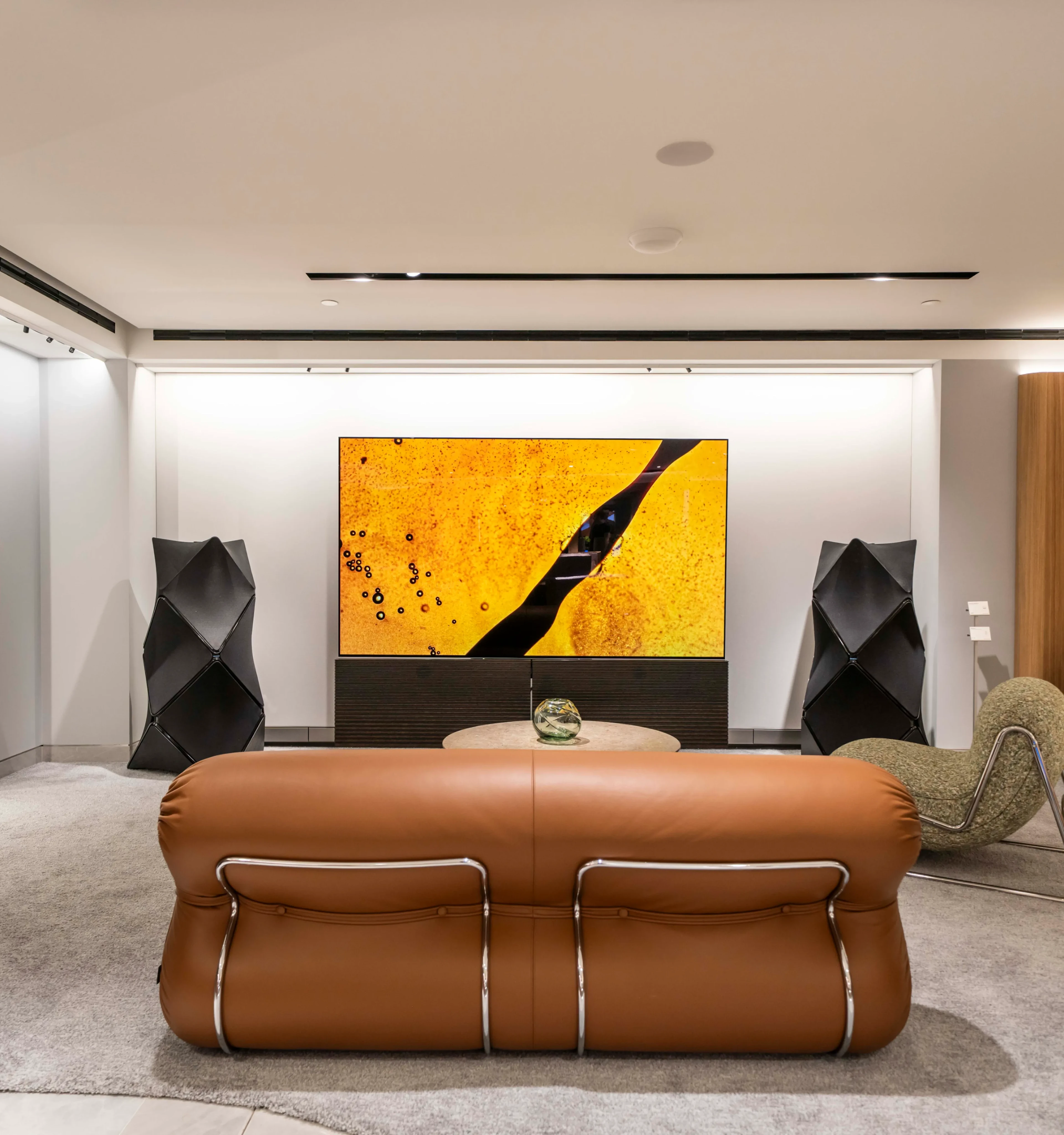 Inside of Bang & Olufsen Harrods store in London. There is a Beovision Harmony TV and a set of Beolab 90 speakers on each side.
