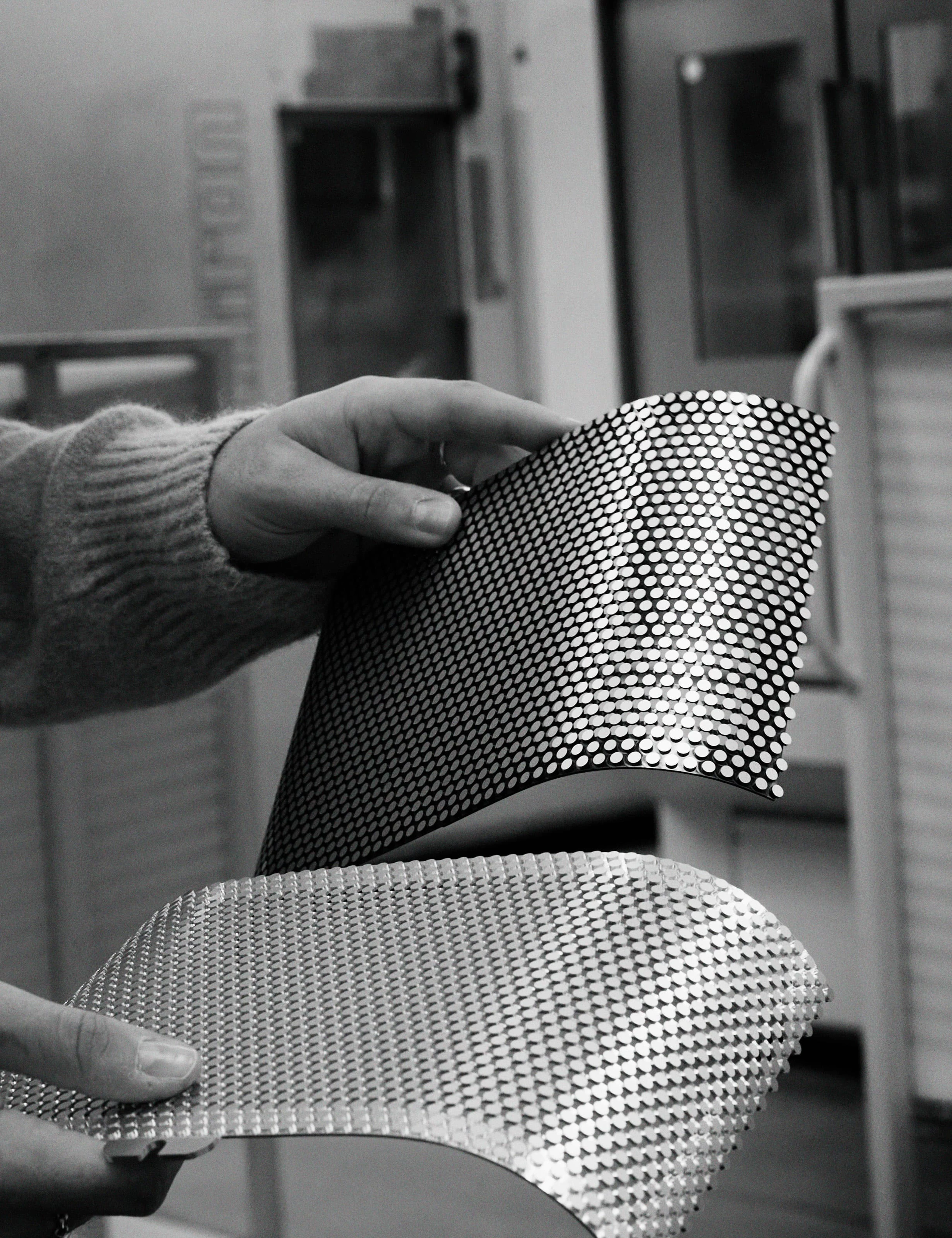 Image of Beosound A5 speaker covers in Spaced Aluminium handled by a Bang & Olufsen factory worker