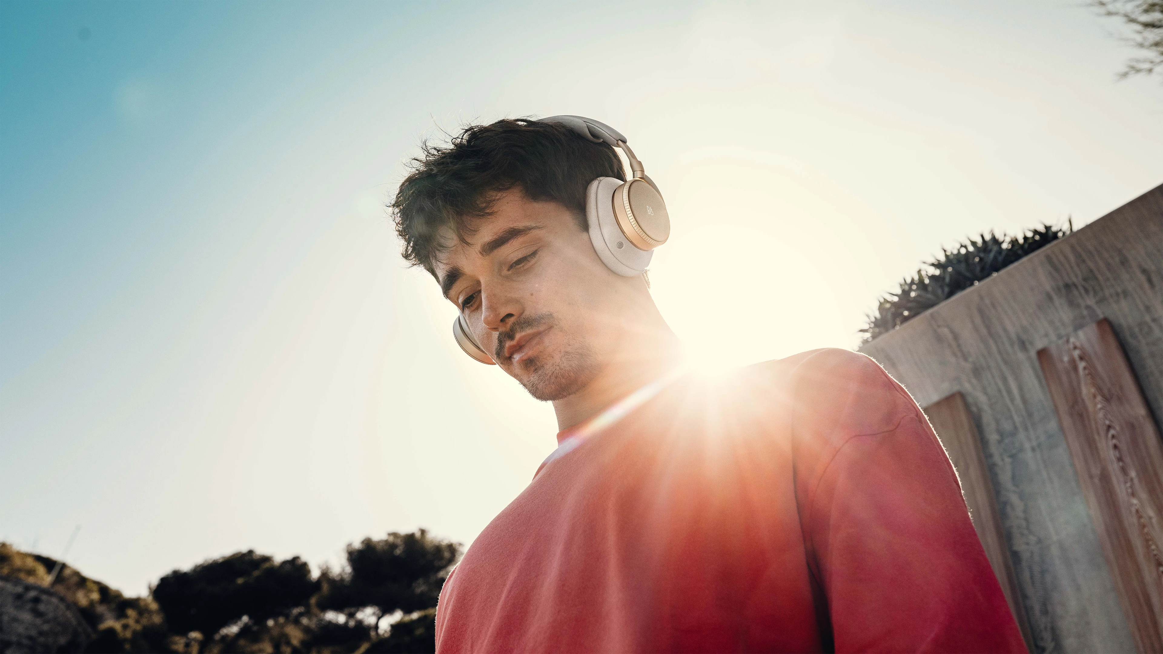 Charles Leclerc wearing Beoplay H100 in sand 