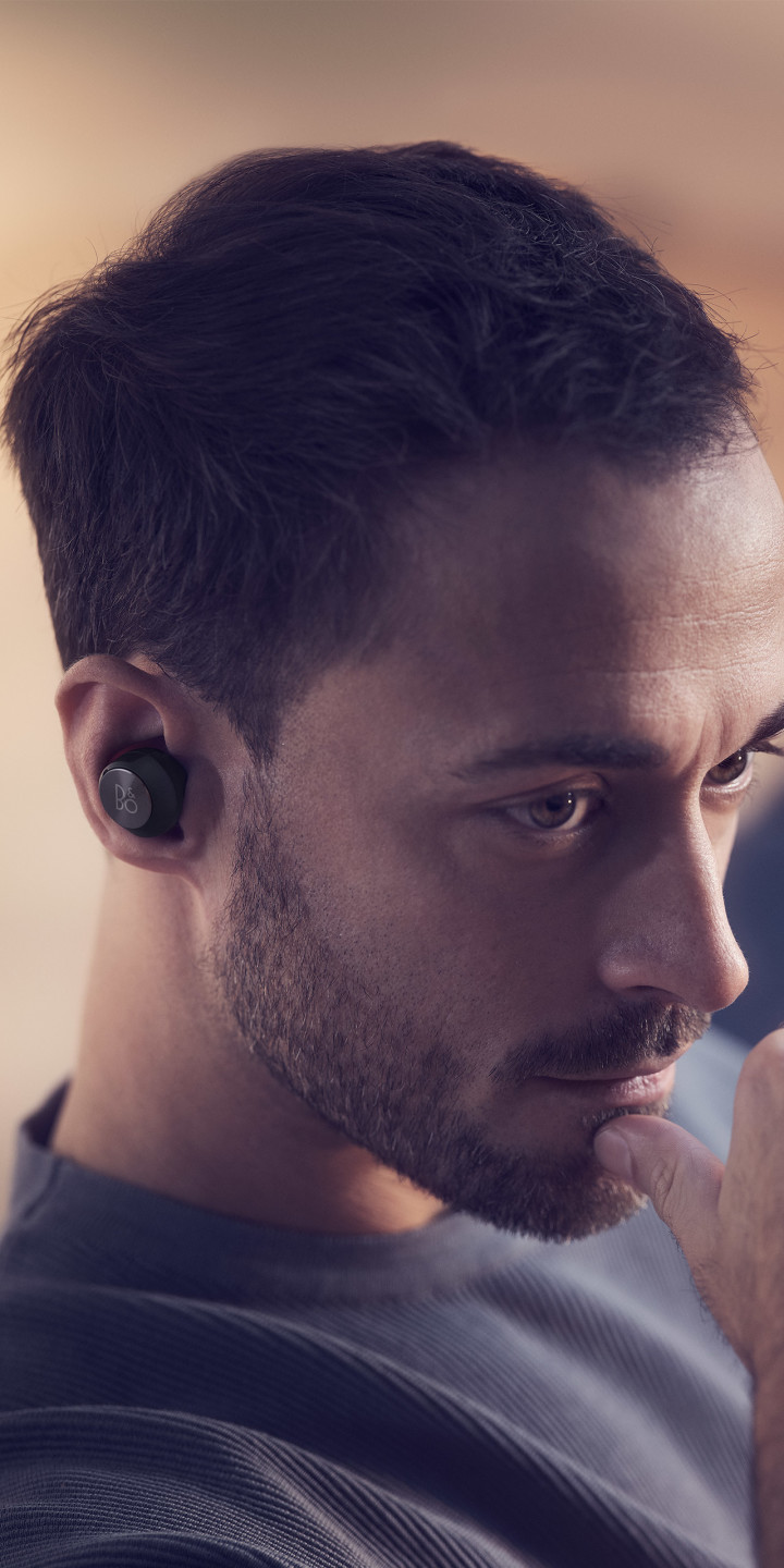 A man wearing Beoplay EQ noise cancelling earphones in black colour