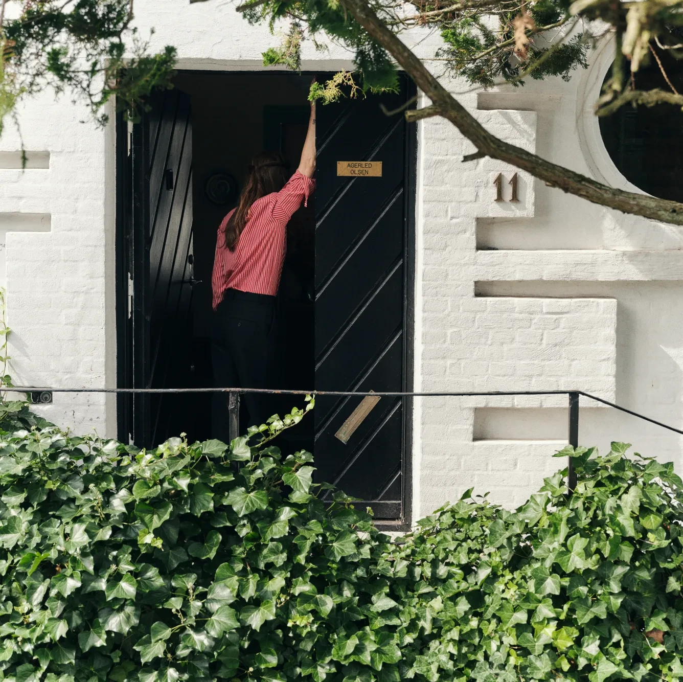 Annika leaning on a door outdoor