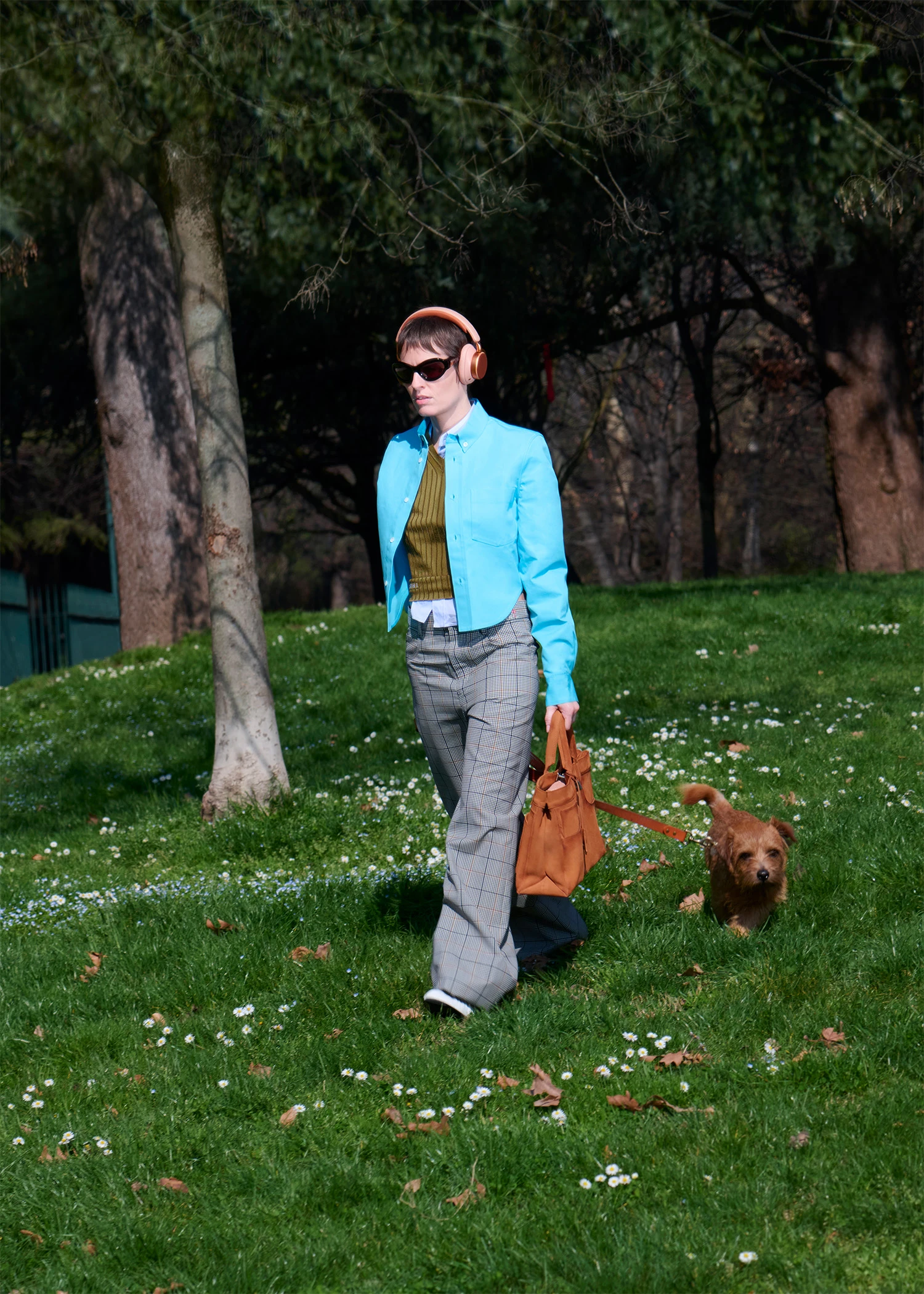 Camilla in the park with dog and Beoplay H100