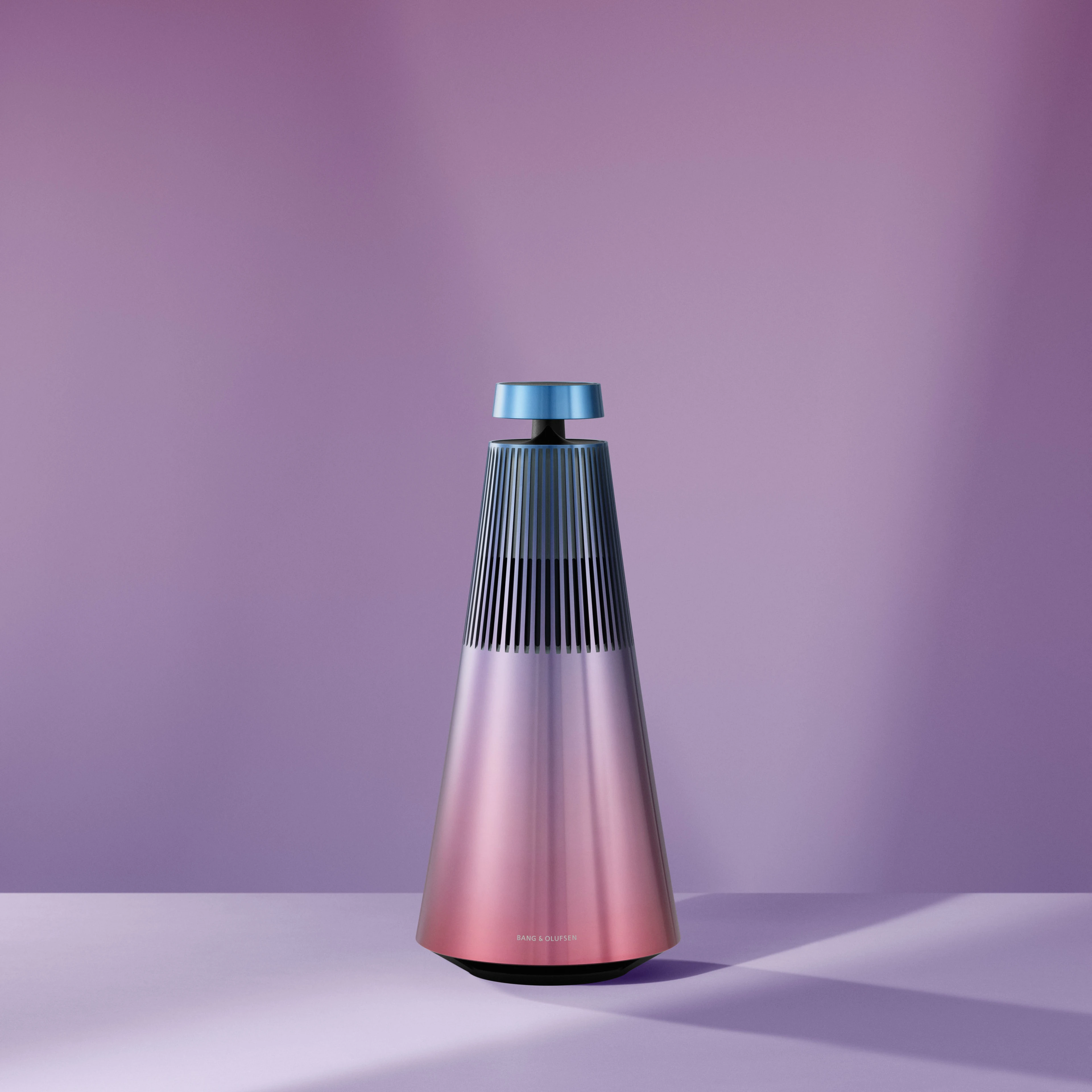 Image of Beosound 2 Atelier Limited Editions speaker in the colour Daybreak Blossom which is a gradient colour of pink, blue and purple