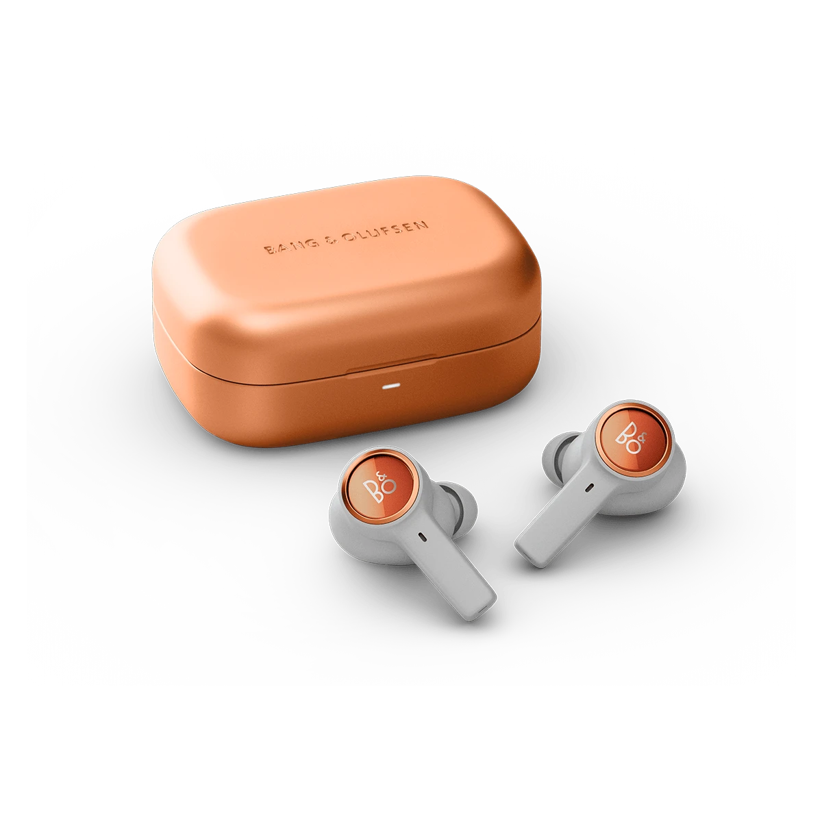 Beoplay Eleven charging case and earbuds Copper Tone placed next to each other