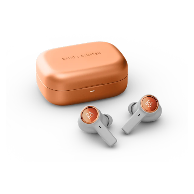 Beoplay Eleven charging case and earbuds Copper Tone placed next to each other