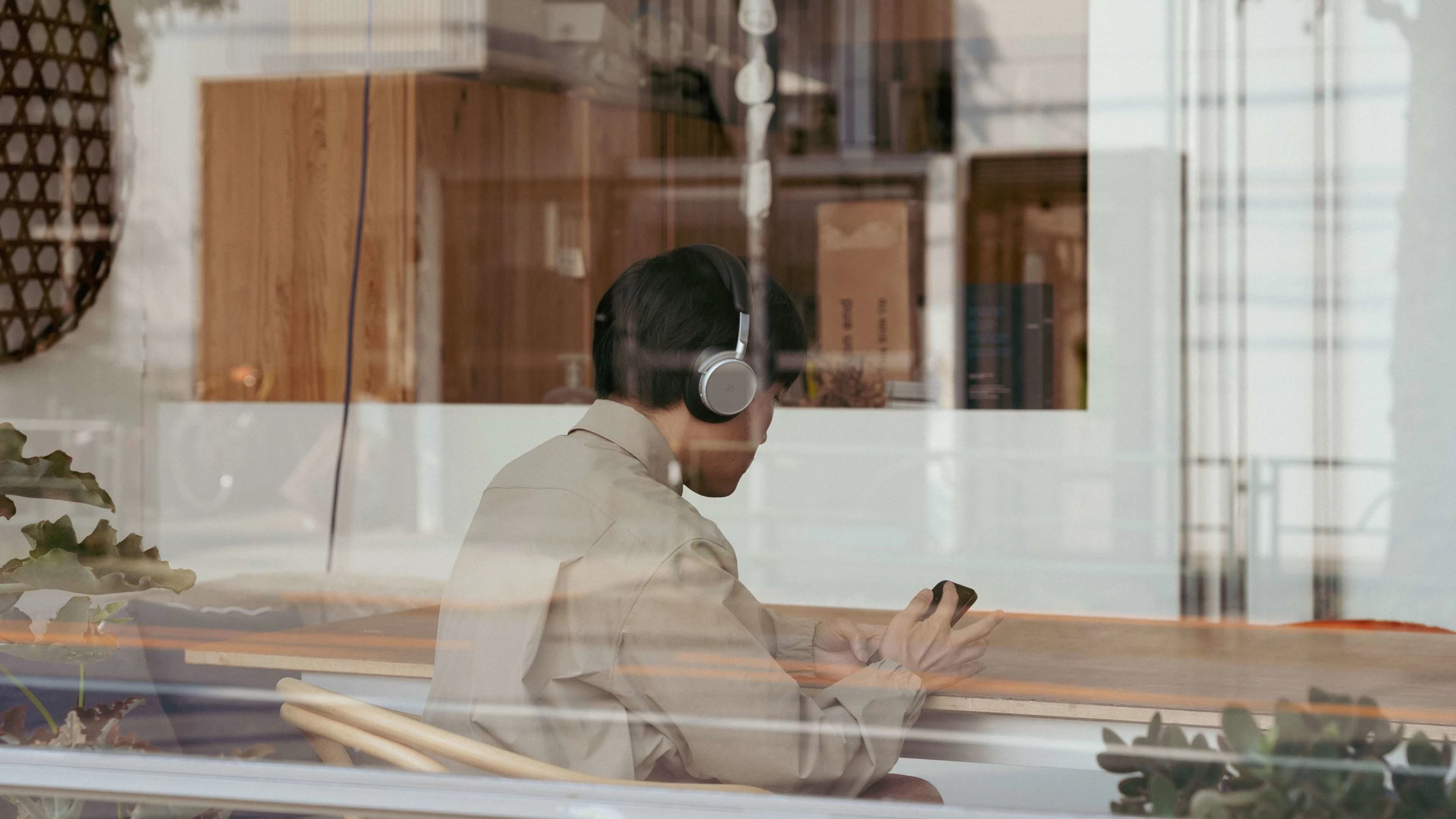 Shuta Hasunuma sitting with the Beoplay H100