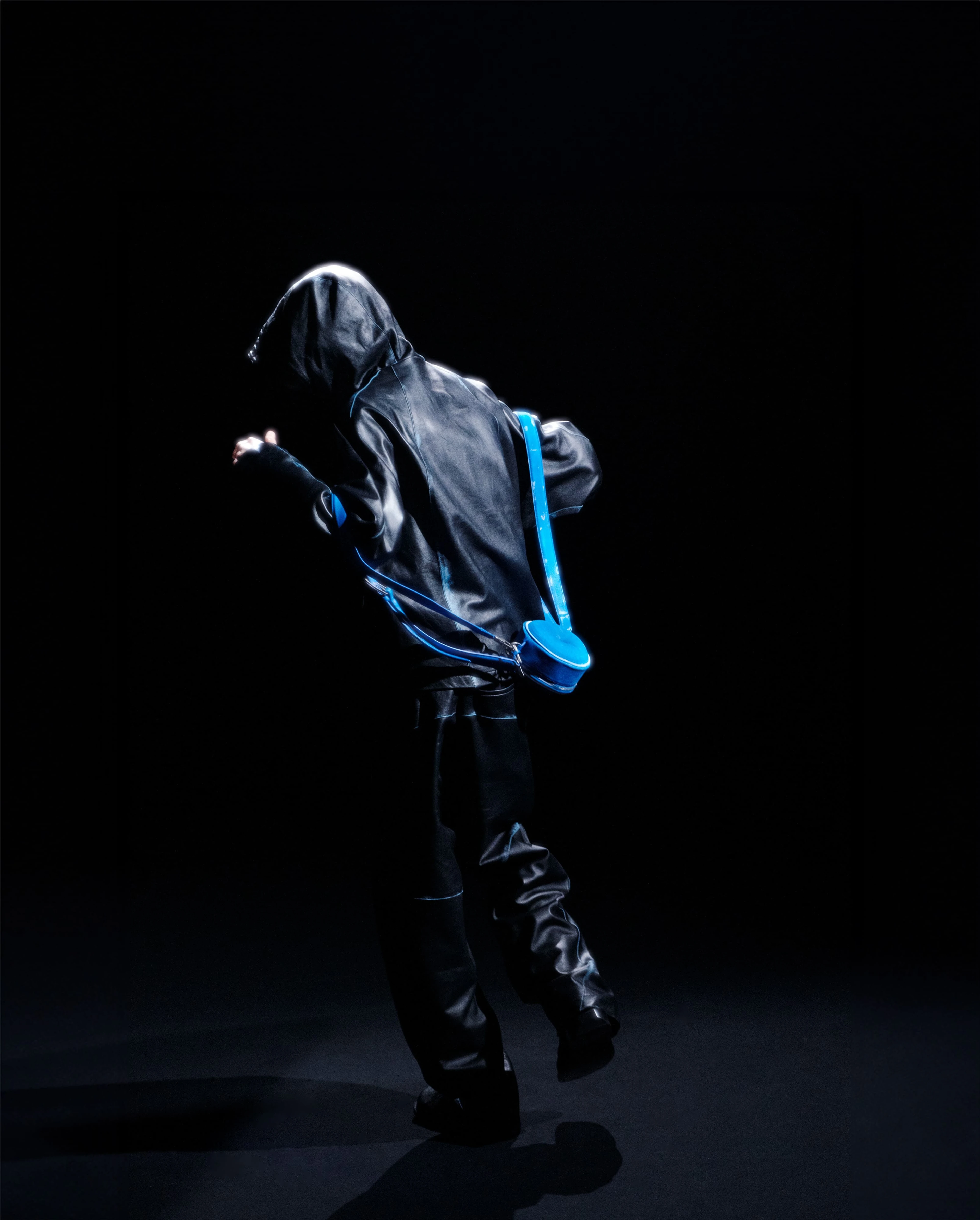 Model wearing Ader Error speaker bag on his back while dancing