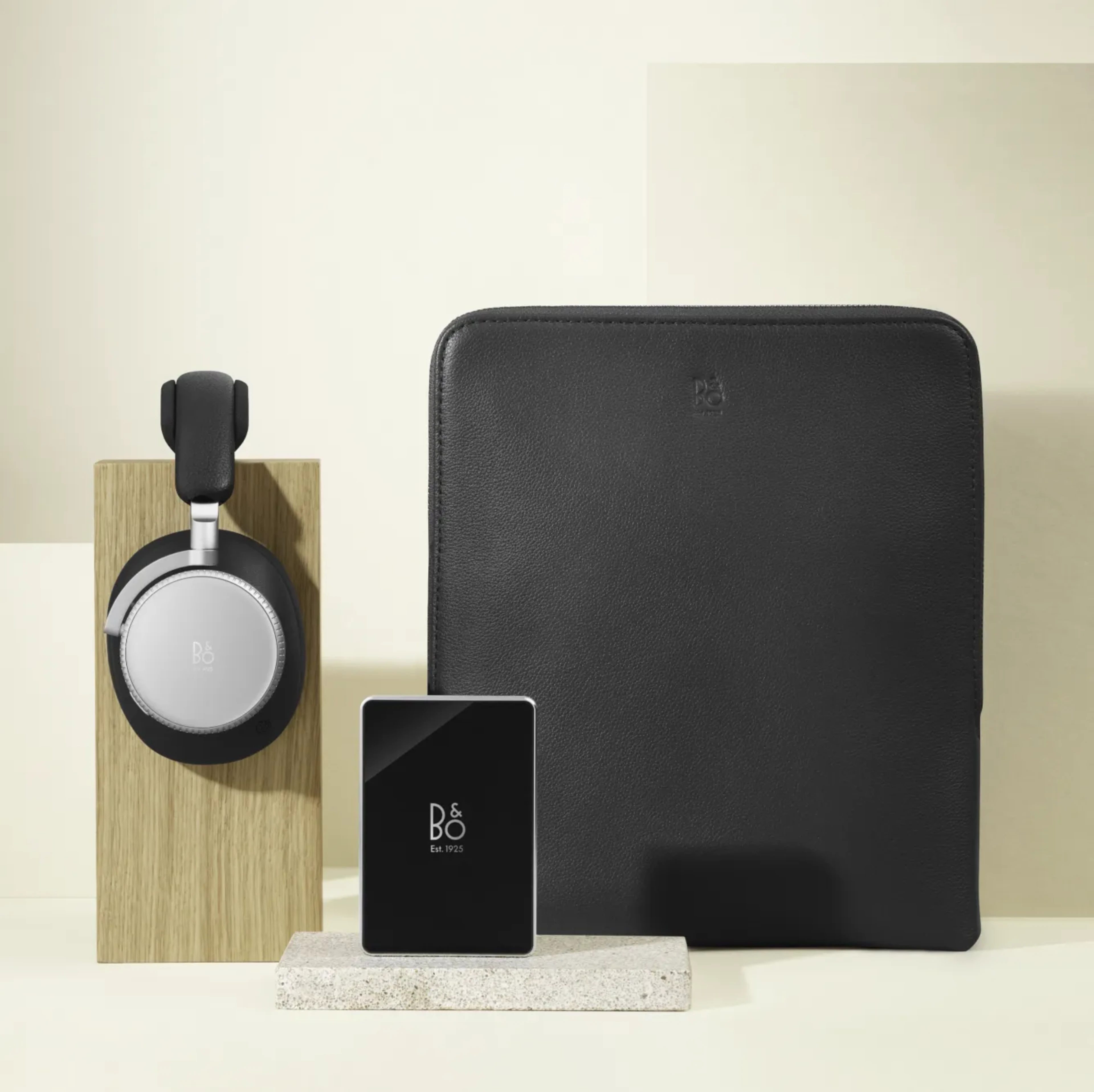Beoplay H100 headphones, with a black pouch and B&O Power Bank