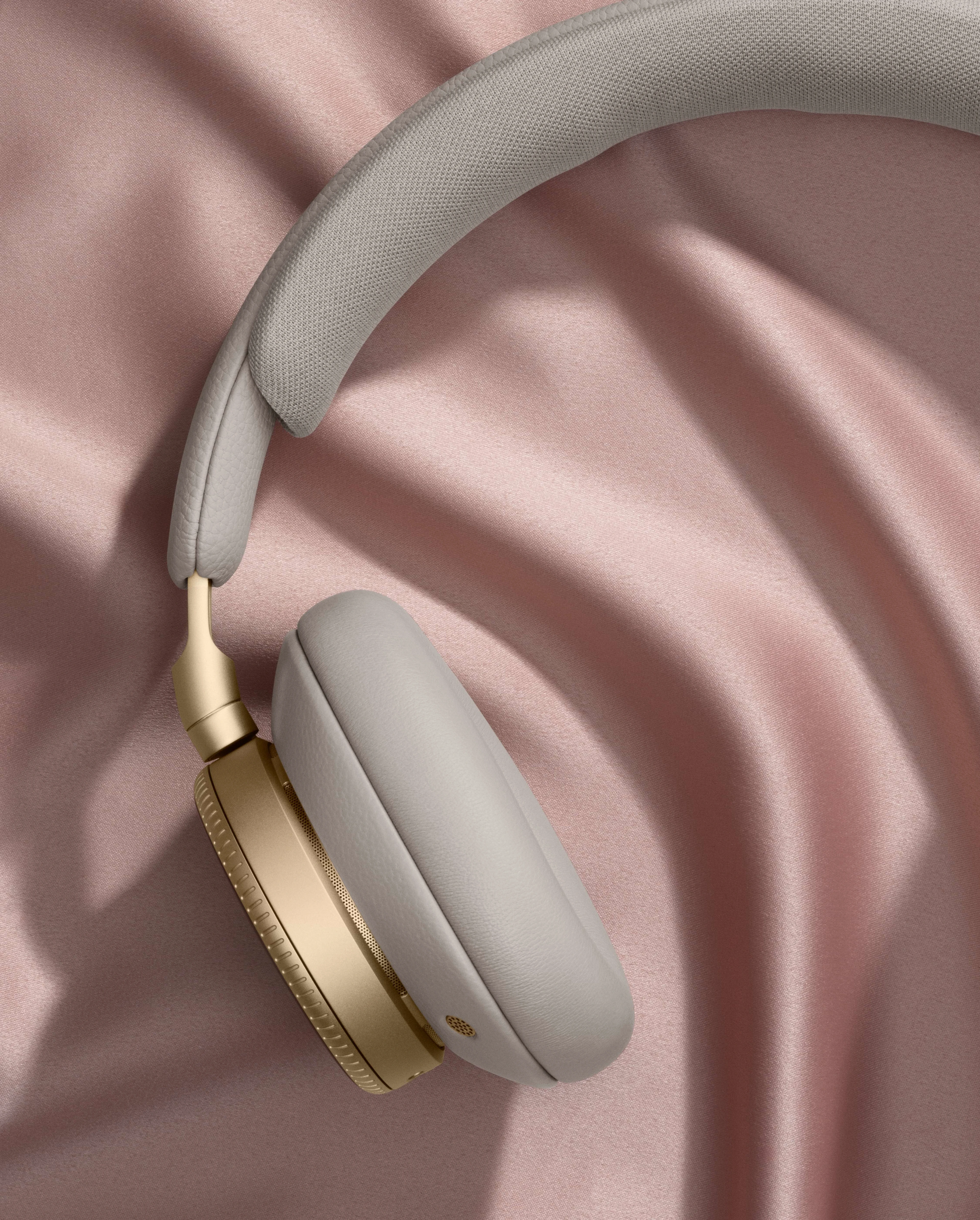 Beoplay laying on pink fabric