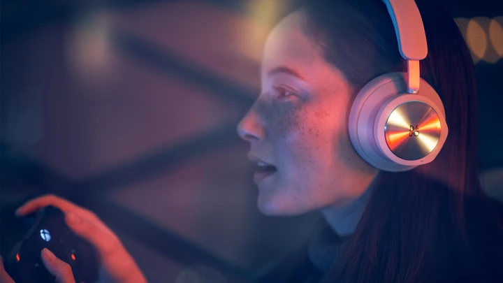 Woman playing XBOX with Beoplay Portal sand