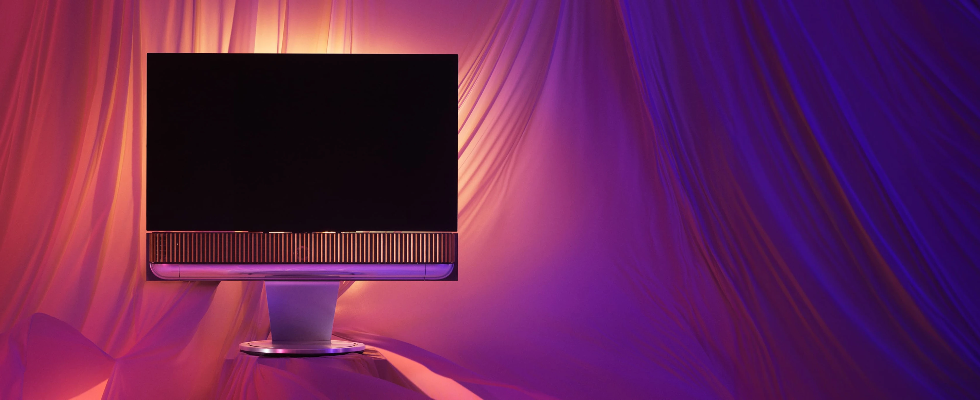 Narrative image of the Beovision Theatre TV experience in natural aluminum with oak front cover on a motorised floor stand