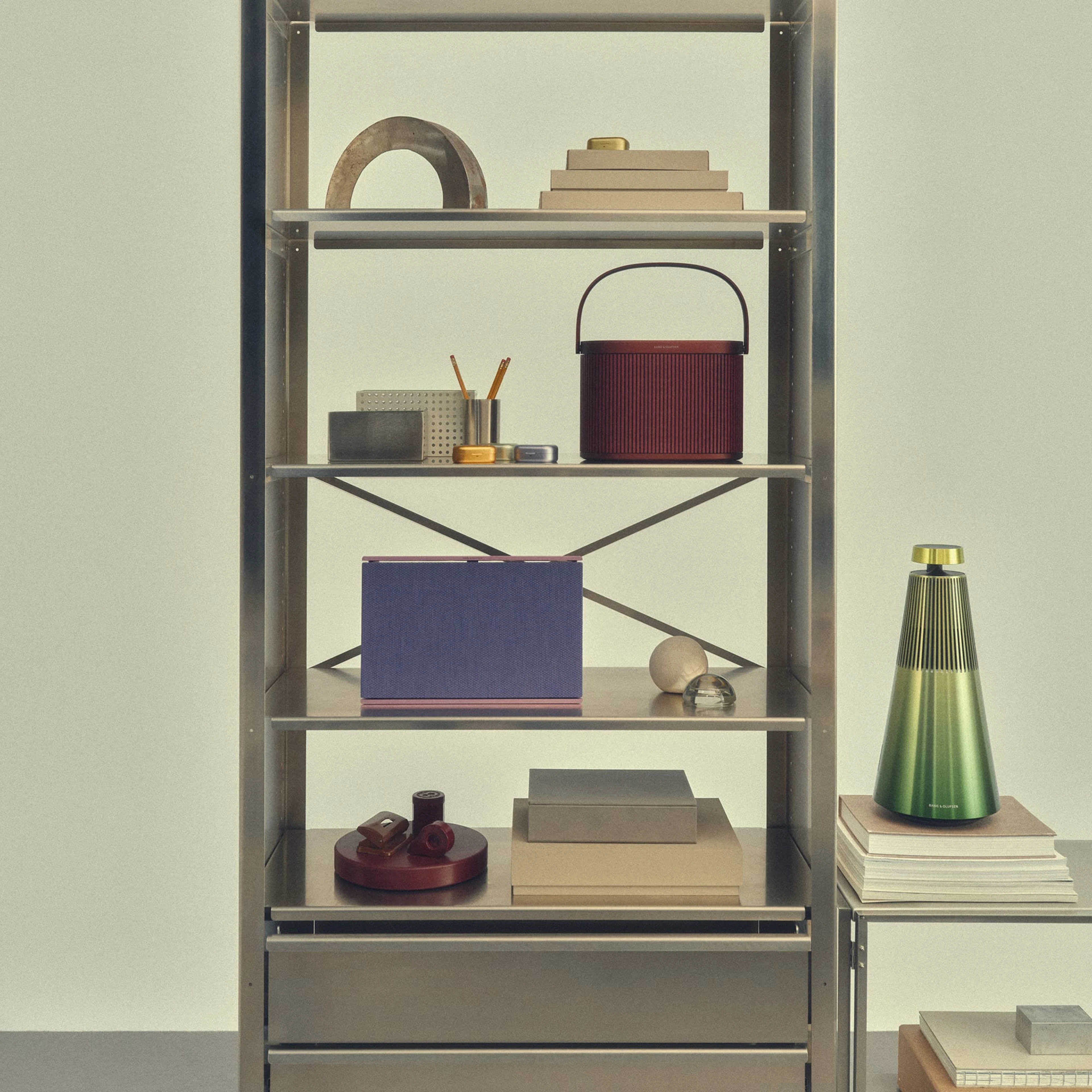 A shelf displaying Beosound A5, Beosound Level and Beosound 2 Atelier Edition