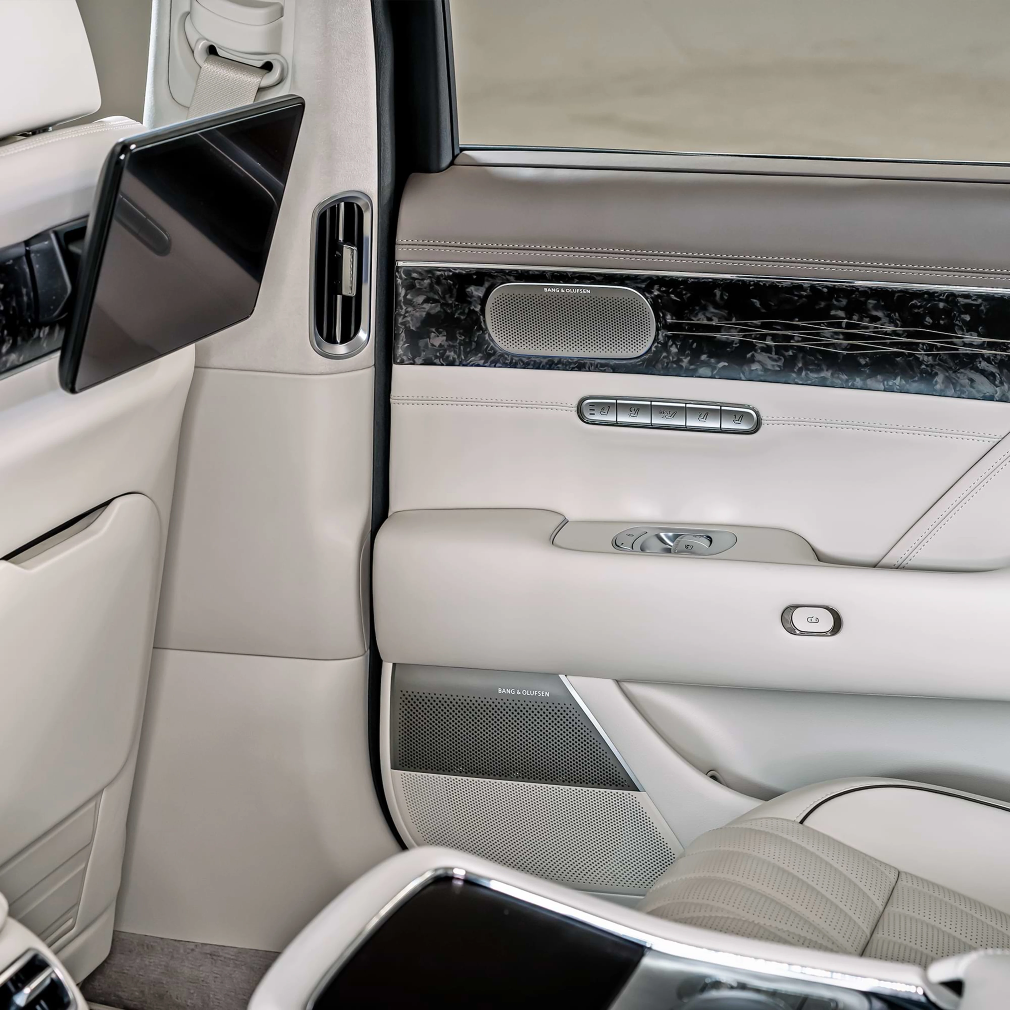 The interior of inside a car were the B&O speakers are being displayed