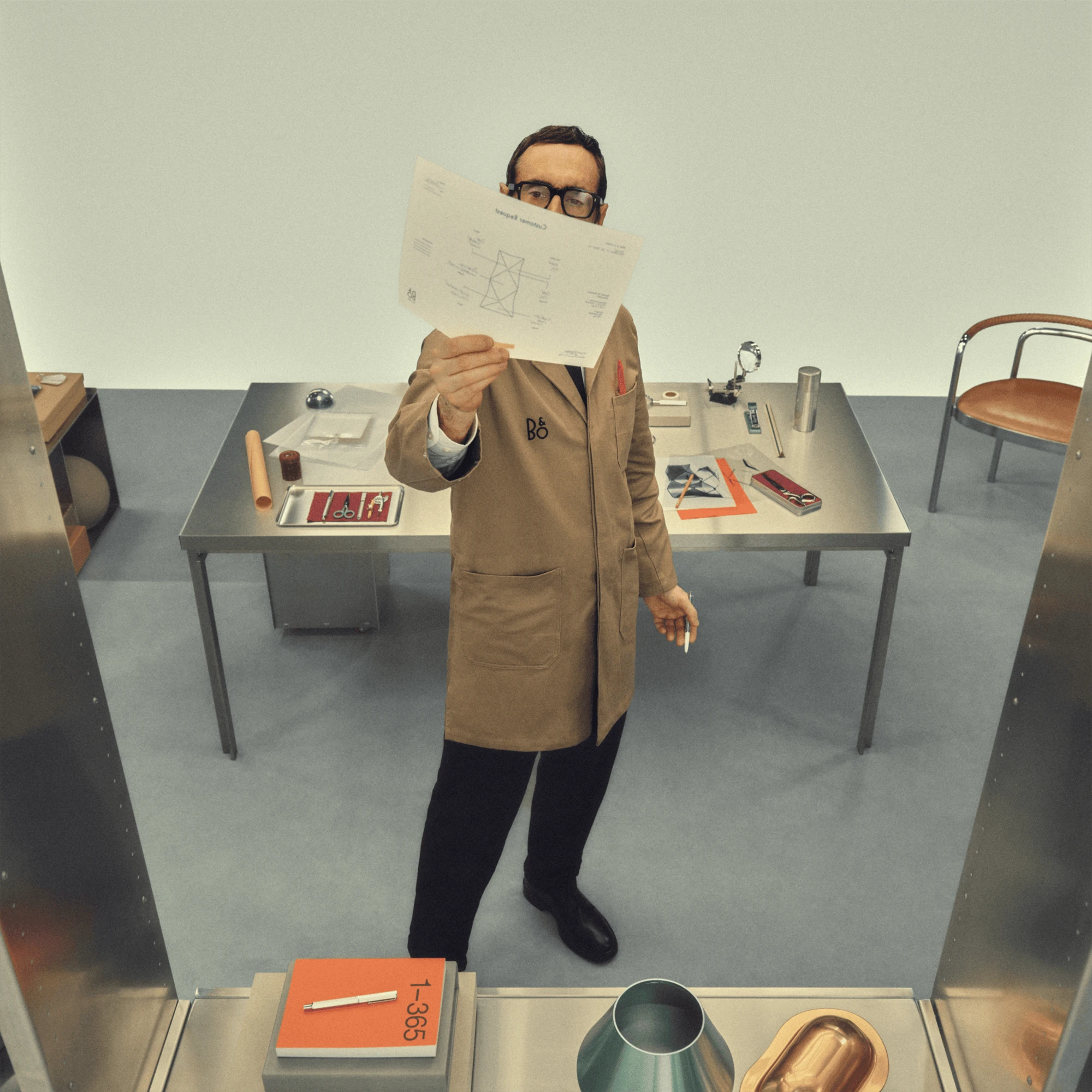 Person checking out a B&O design on paper
