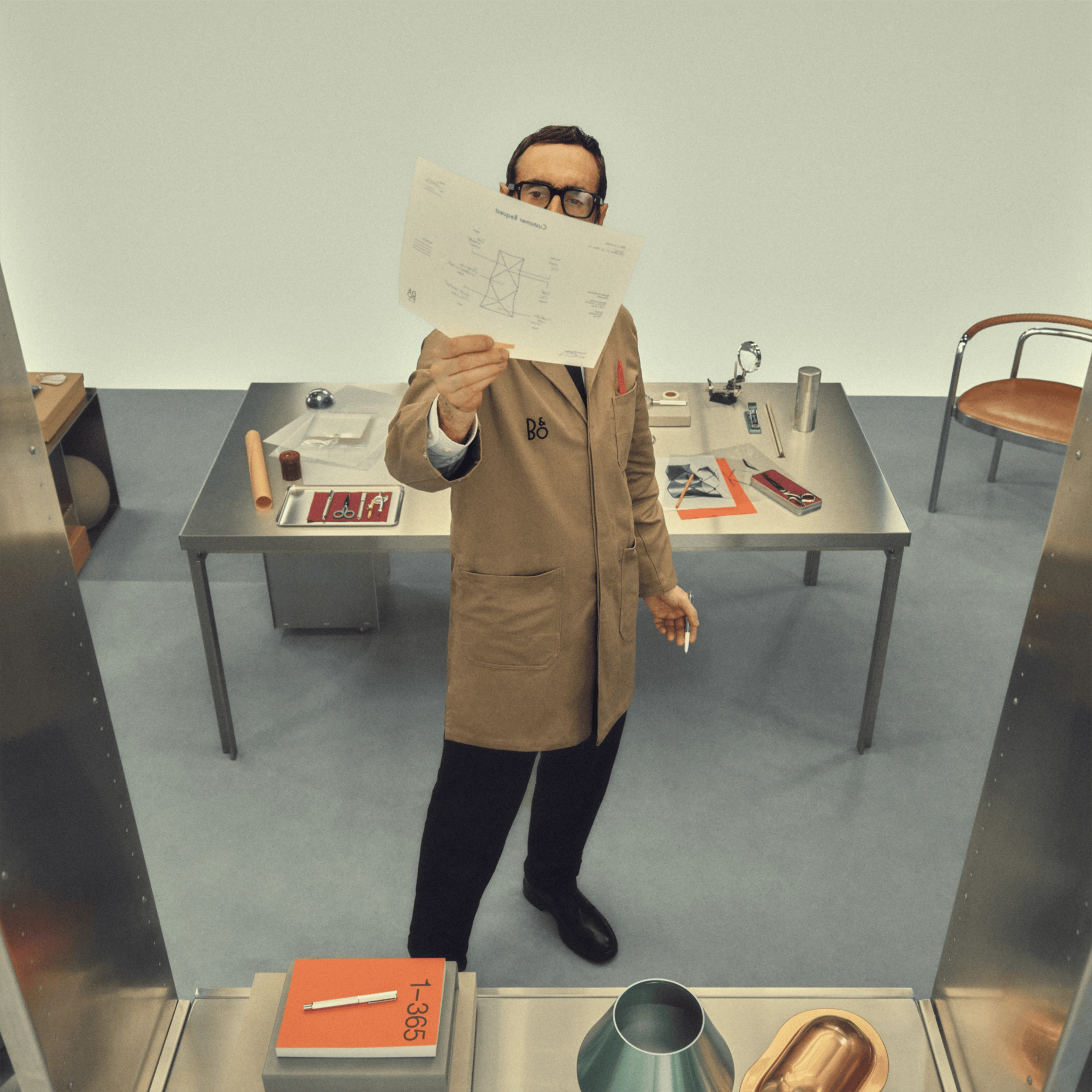 Person checking out a B&O design on paper
