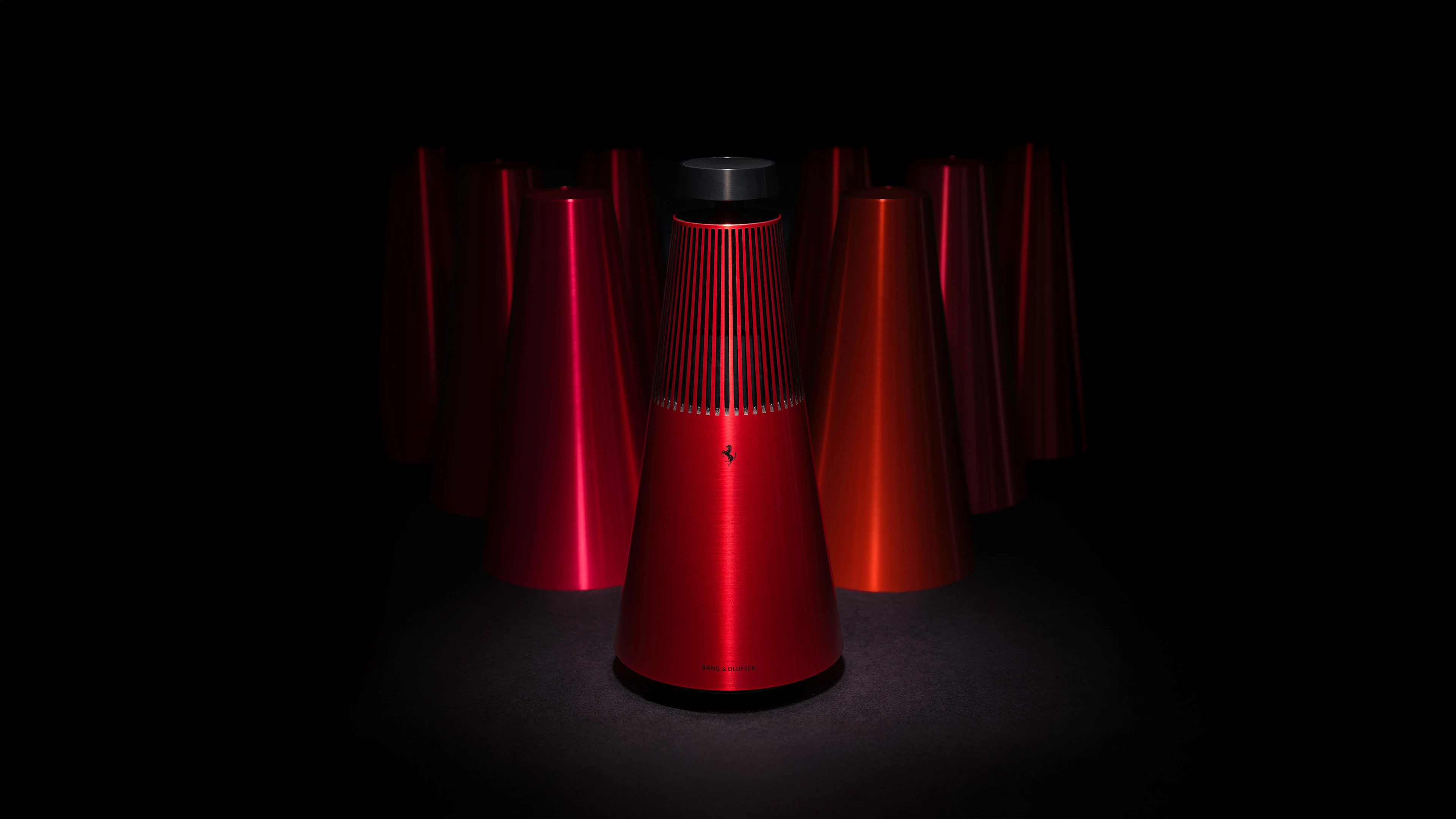 Beosound 2 Ferrari edition on a dark background, emphasizing the red color