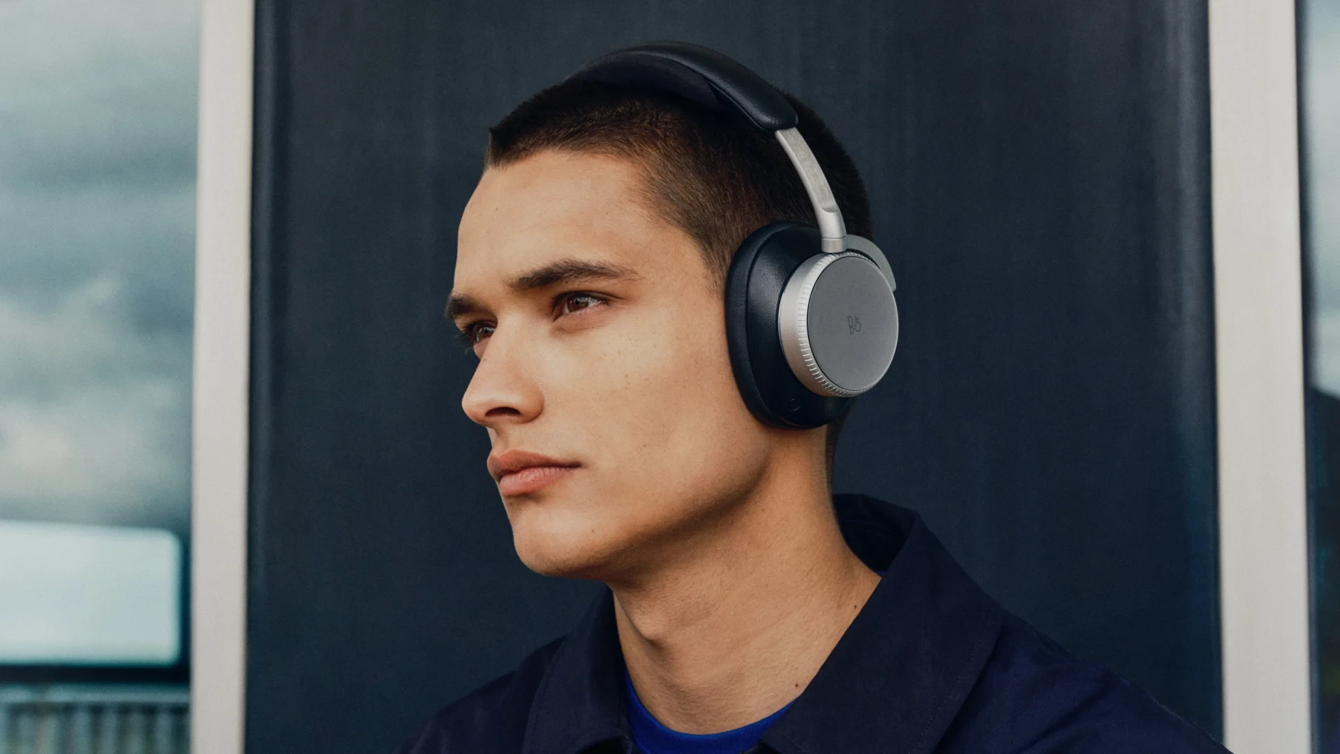 A man wearing Beoplay H100 