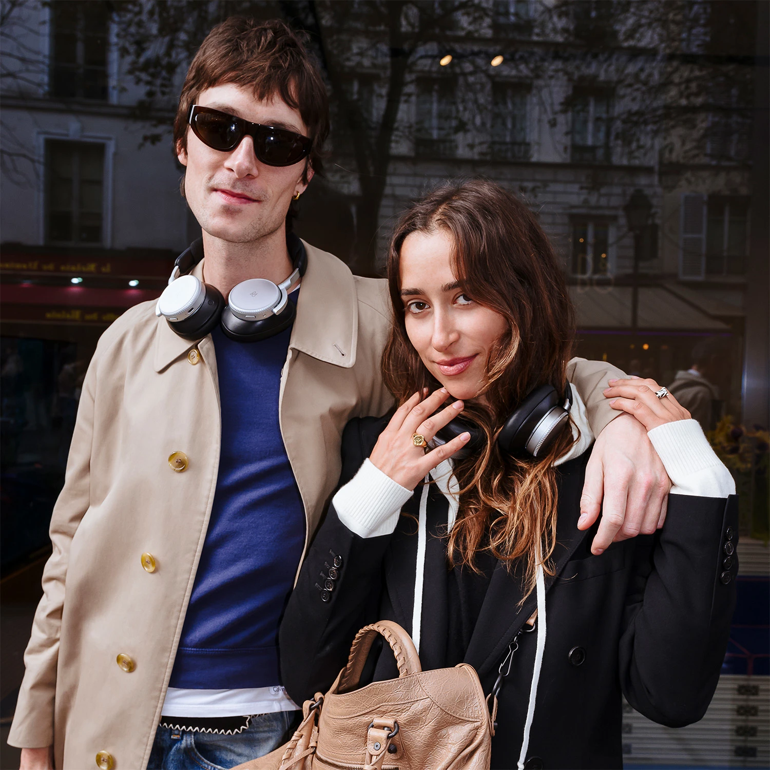 A couple posing wearing Beoplay H100 headphones 