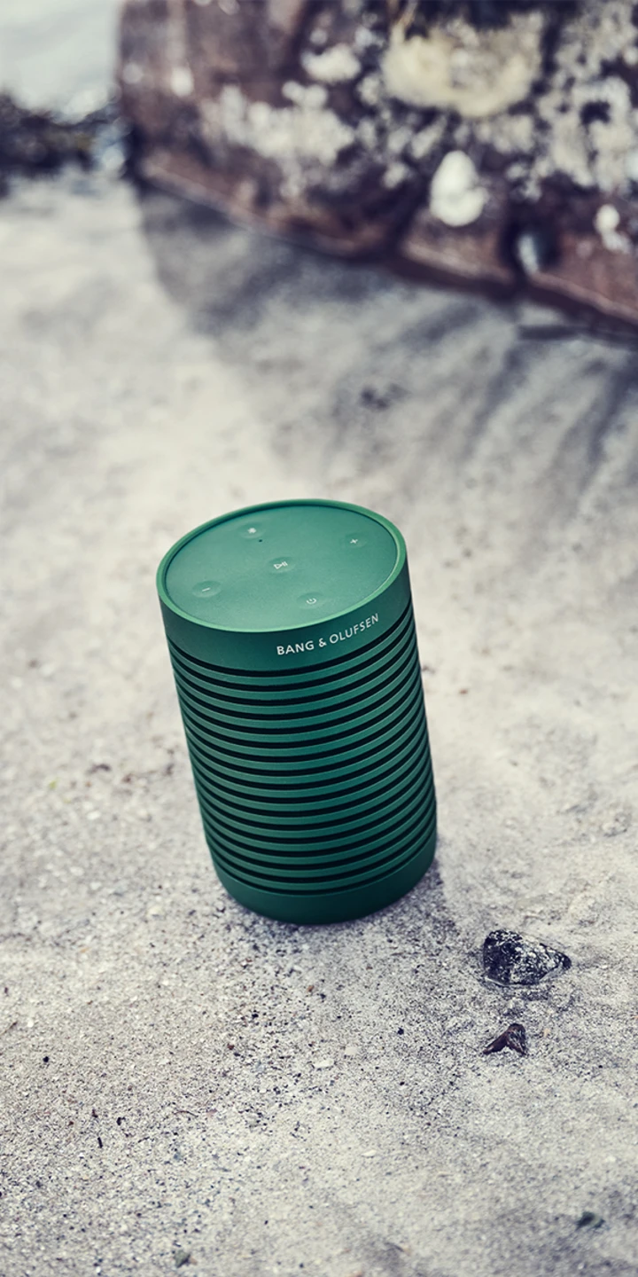 Beosound Explore outdoor speaker on a beach