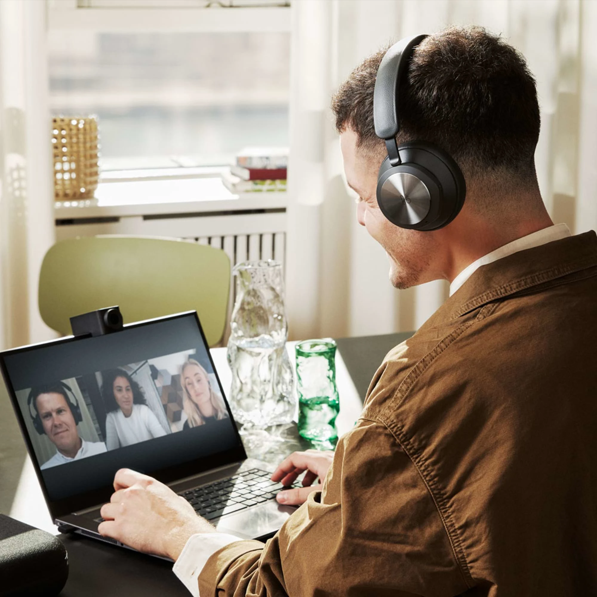 Person sitting in meeting with the Beoplay Portal