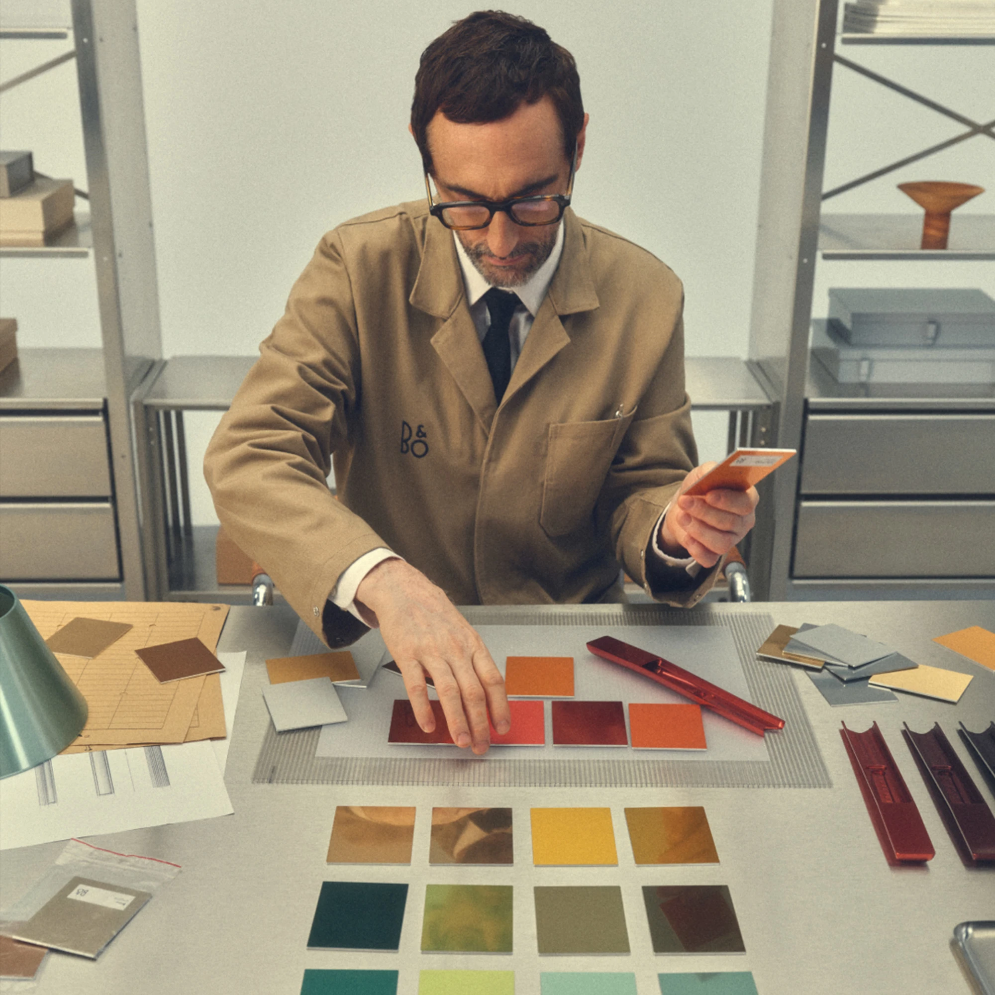 Man choosing different card colors, with one in his hand.
