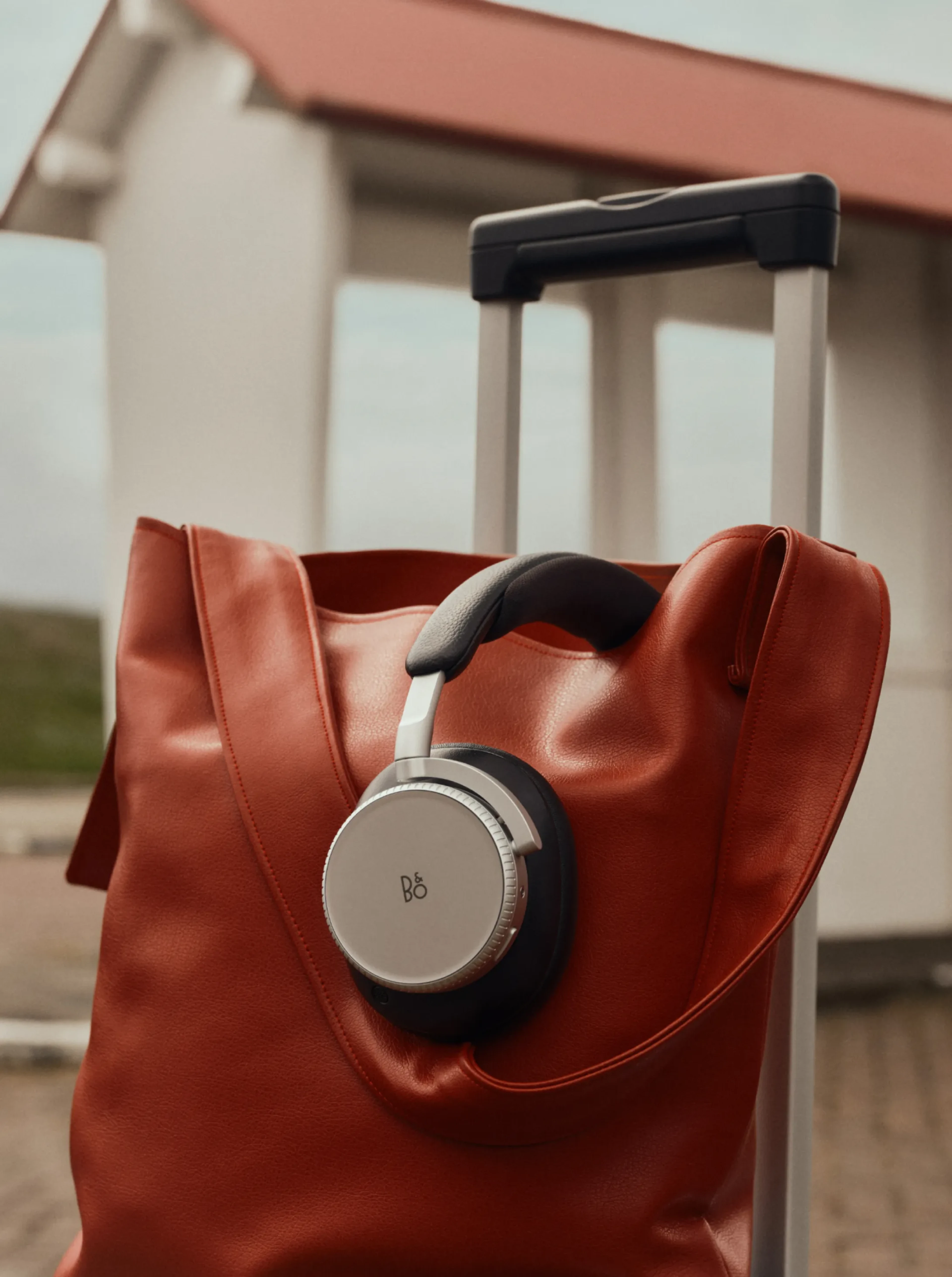 Beoplay H100 hanging on a bikes steer