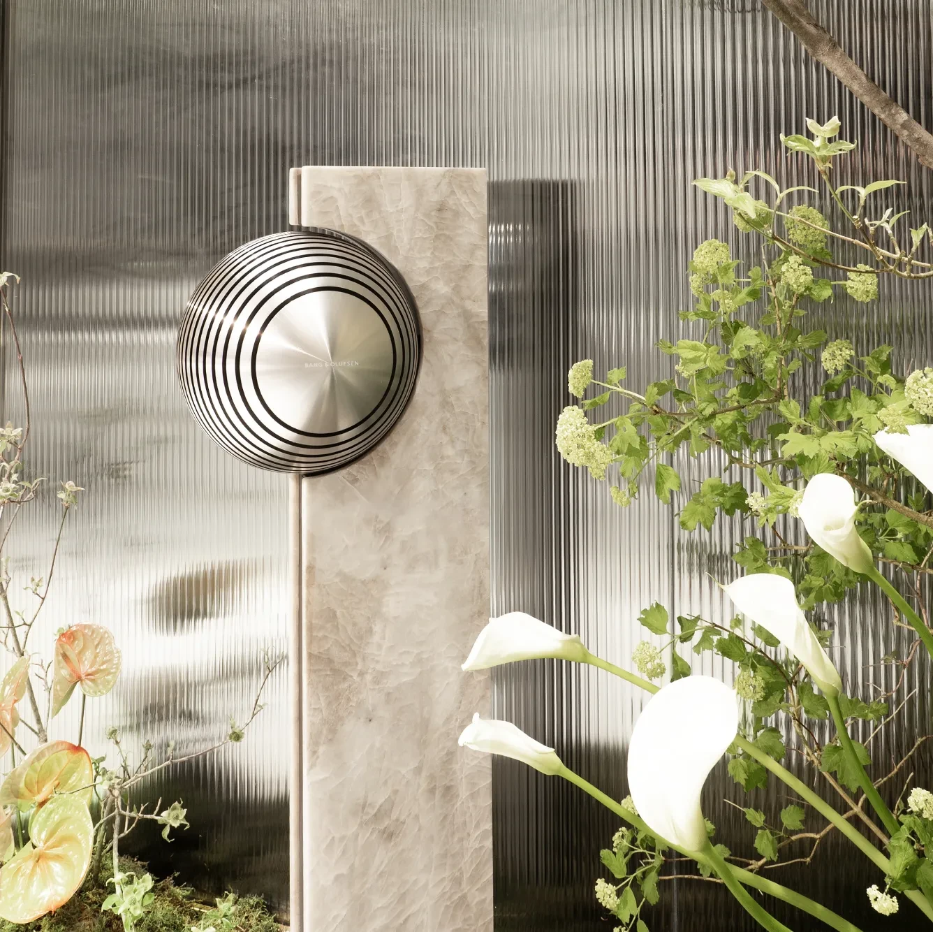 Beosound Haven in a outside environment with plants