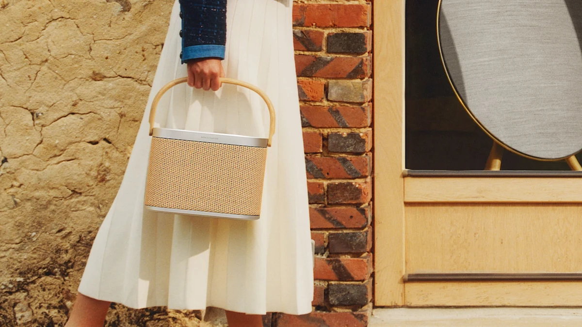 A person carrying the Bang & Olufsen Beosound A5 portable speaker outdoors