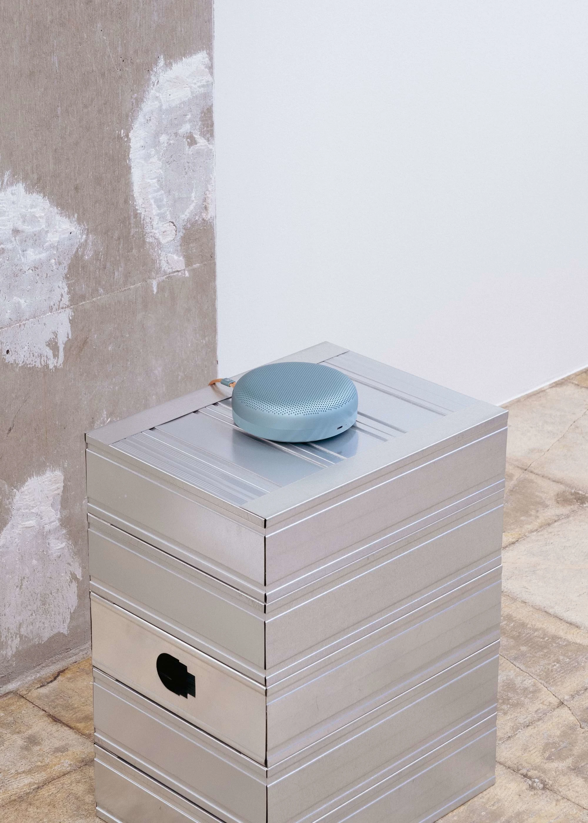 Beosound A1 laying on a surface in a warehouse