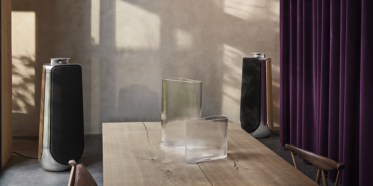 A pair of Beolab 50 in Natural Aluminium and a dining table