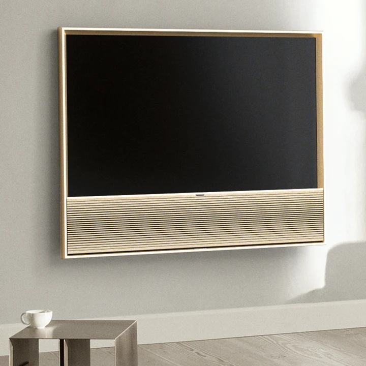 Beovision Contour Gold Oak on a wall in a bright livingroom