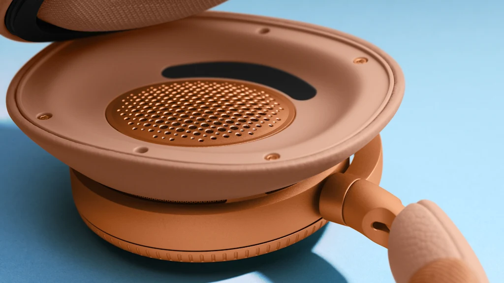 Detail shot of Beoplay H100 headphones under ear cushion in the colour Sunset Apricot