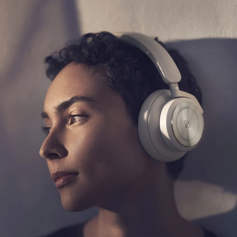 A woman wearing Beoplay HX Sand for a comfortable listening experience
