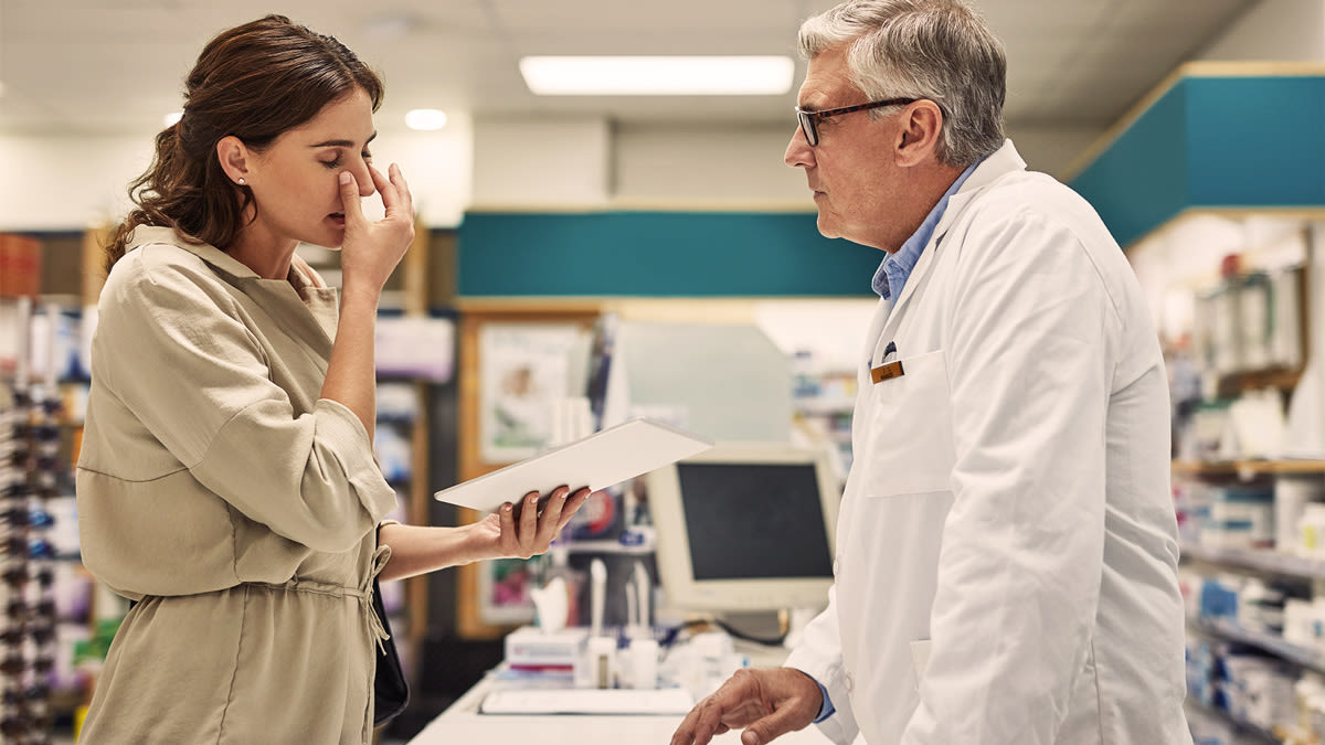 Woman discussing symptoms with doctor