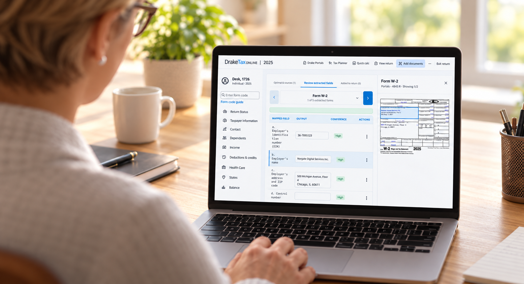 A person uses Drake Tax Online on a laptop to review tax return details and uploaded documents