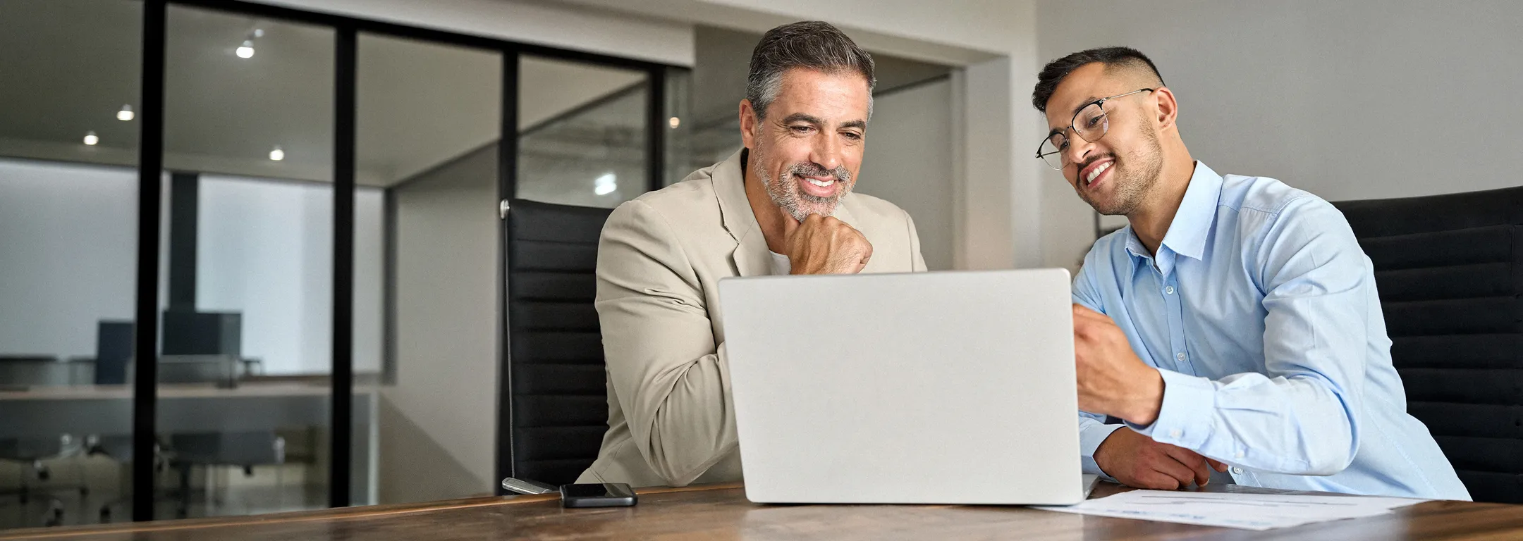 Two tax professionals reviewing a return together on a laptop