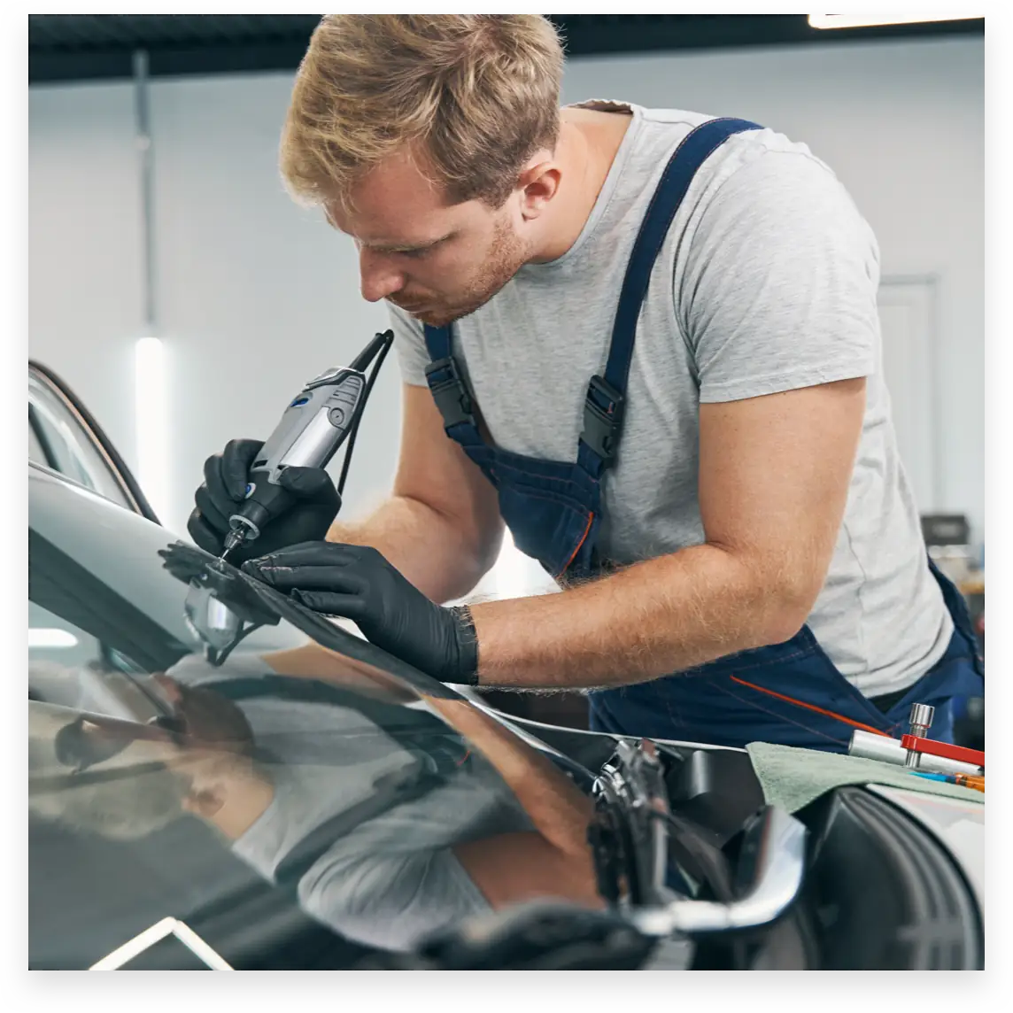 Person fixing car windshield