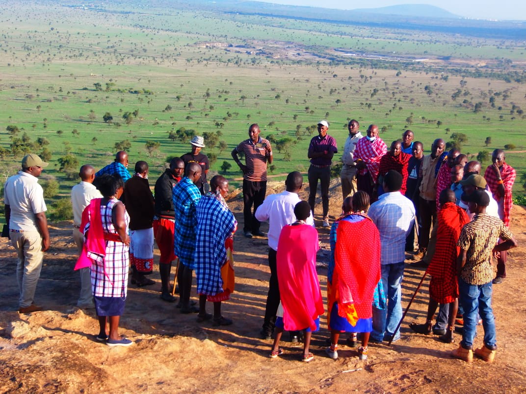 People standing around in a circle talking