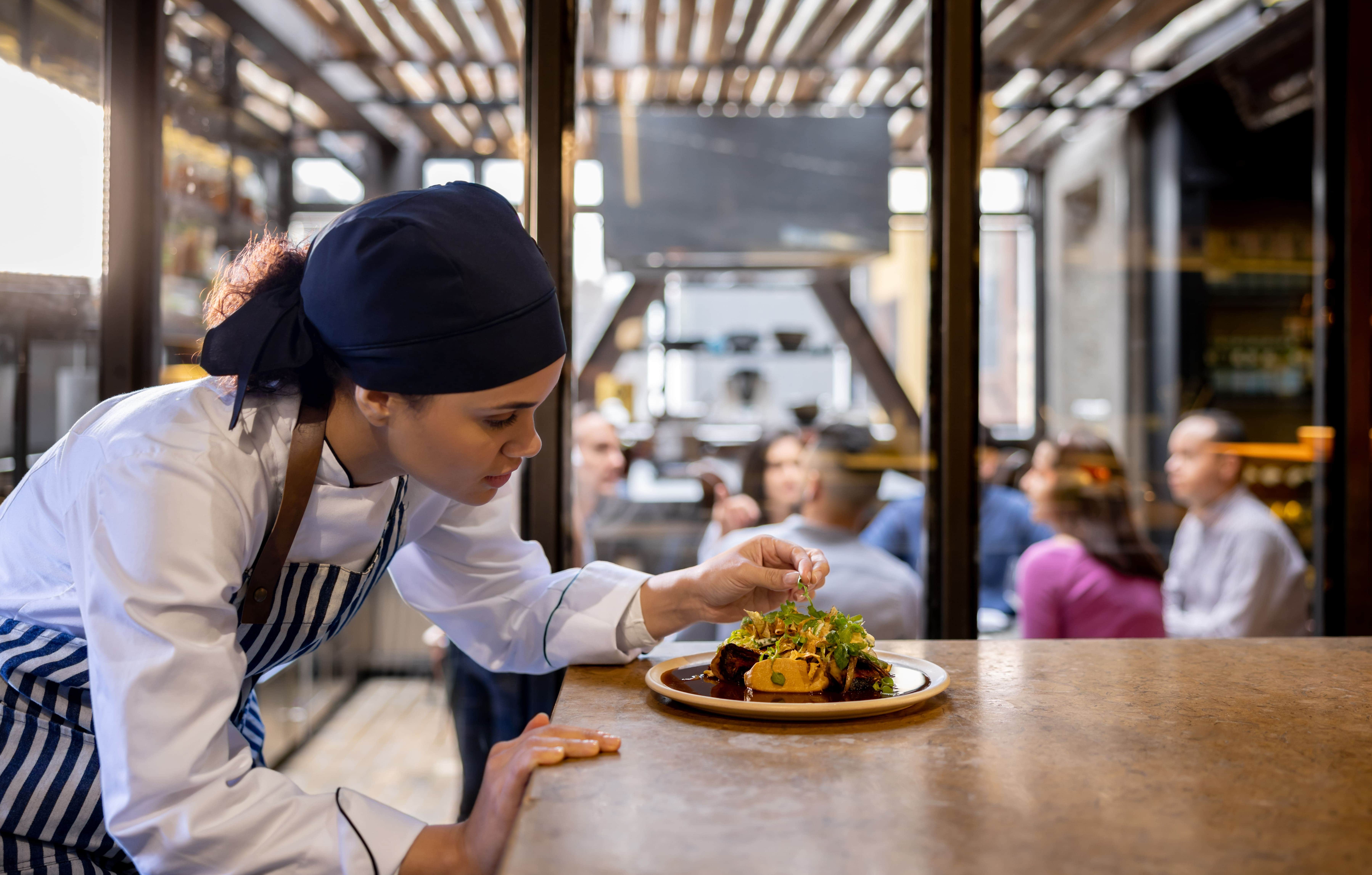 Restaurant chef adding garnish