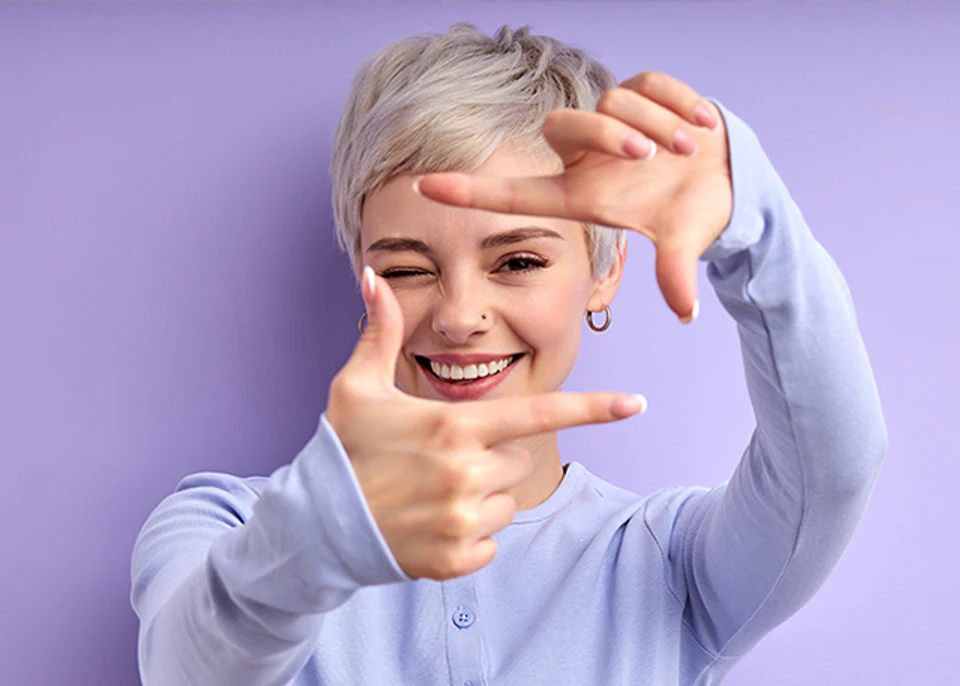 Cheerful happy woman with short hair laughing, feeling happiness